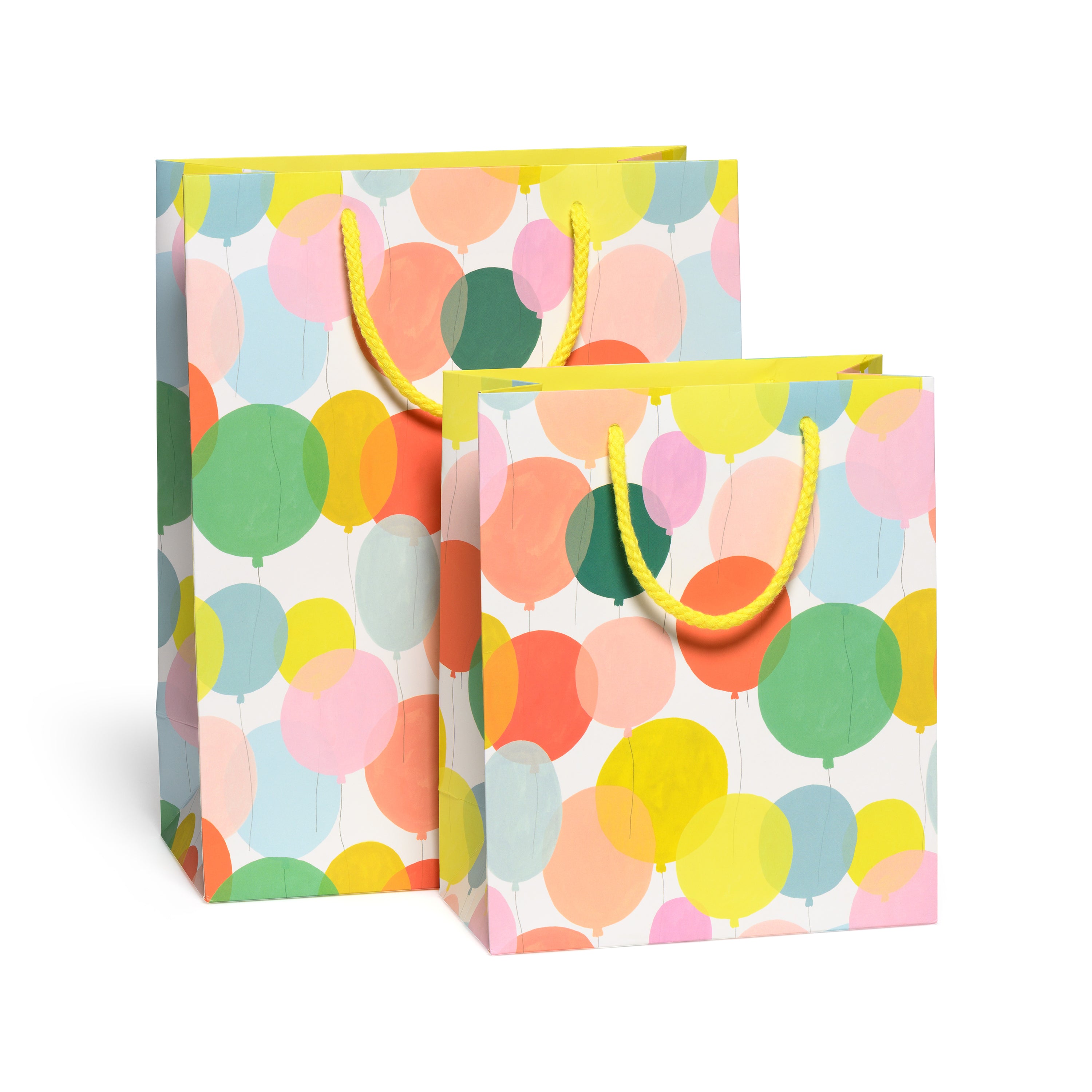 Two gift bags with a colorful balloon pattern and a yellow rope handle.