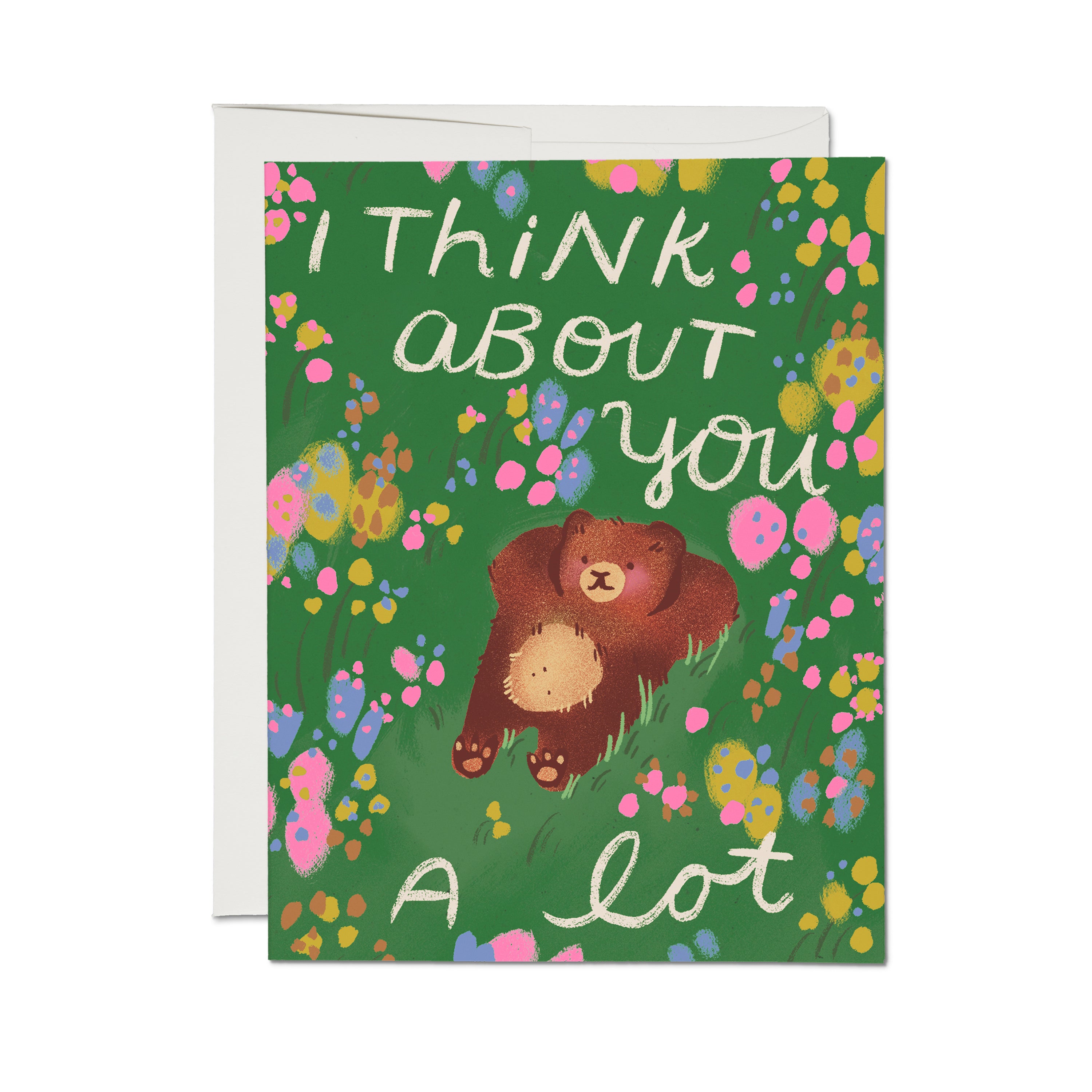 Friendship greeting card with illustrated bear relaxing in colorful flower field and 'I Think About You A Lot' text