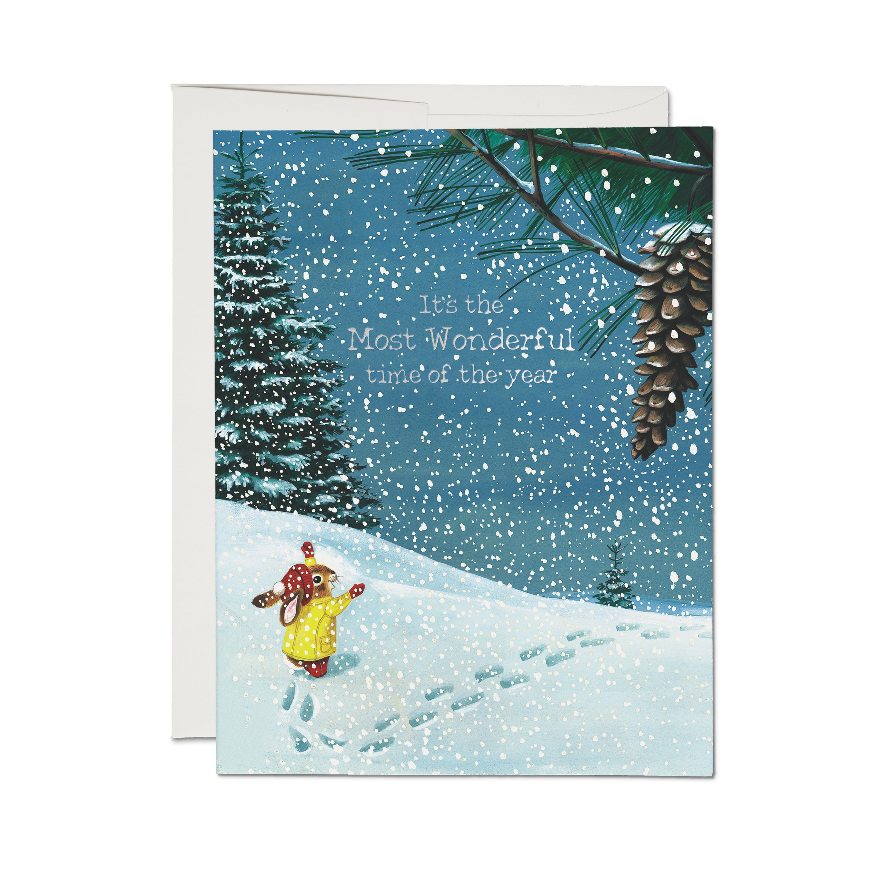 Christmas card with a bunny in a yellow coat walking in snow with silver foil 'It's the Most Wonderful Time of the Year' text.