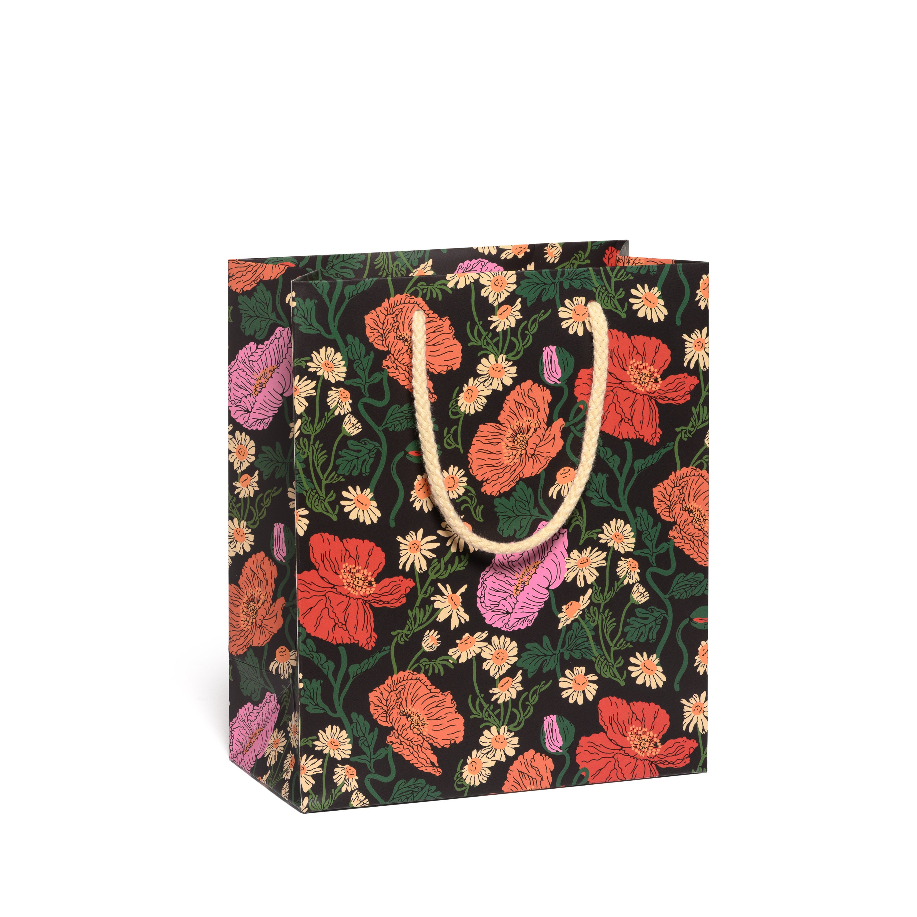 Floral-patterned paper bag with a yellow rope handle on a black background.