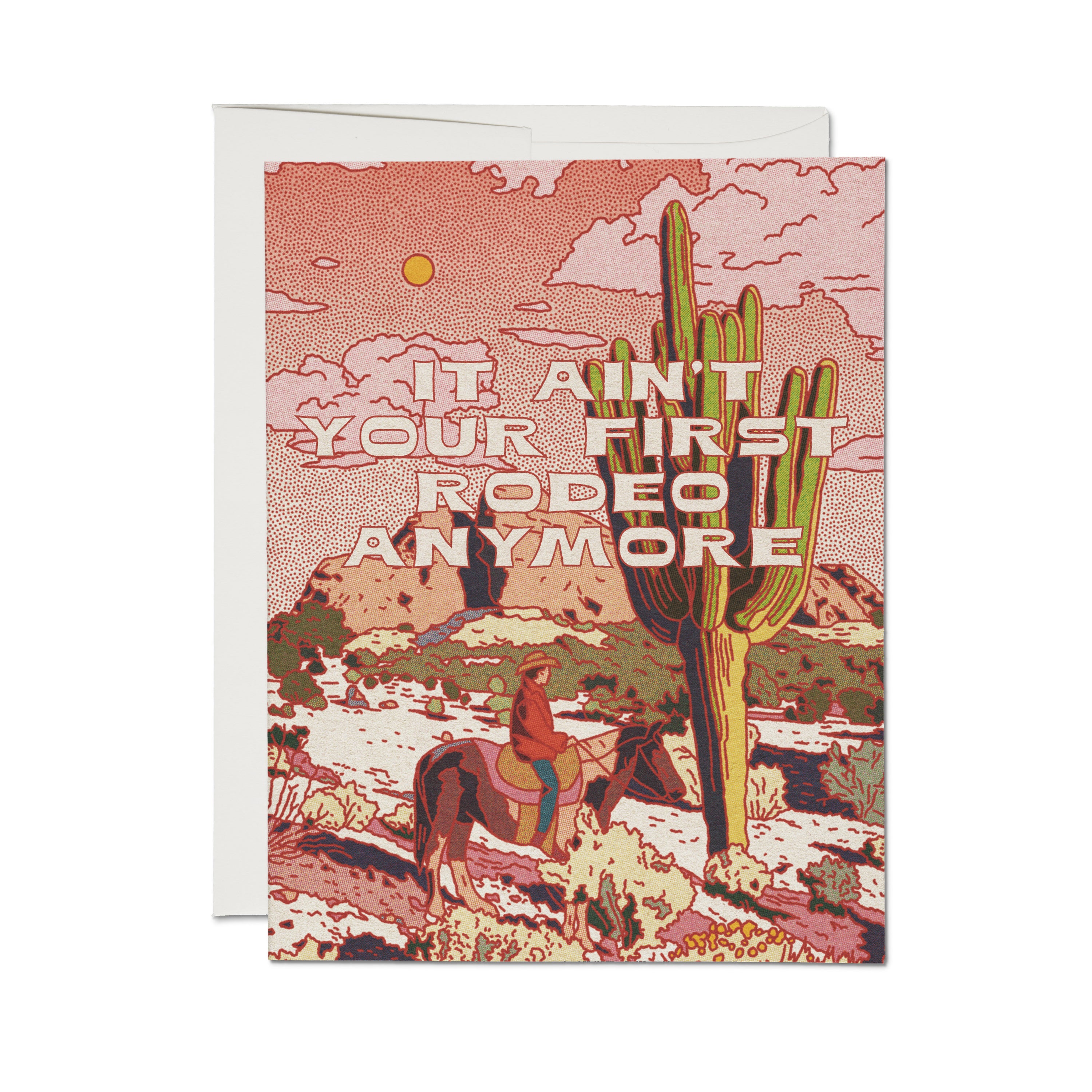 "It Ain't Your First Rodeo Anymore" card with a cowboy on horseback among saguaro cacti in a desert landscape at sunset.
