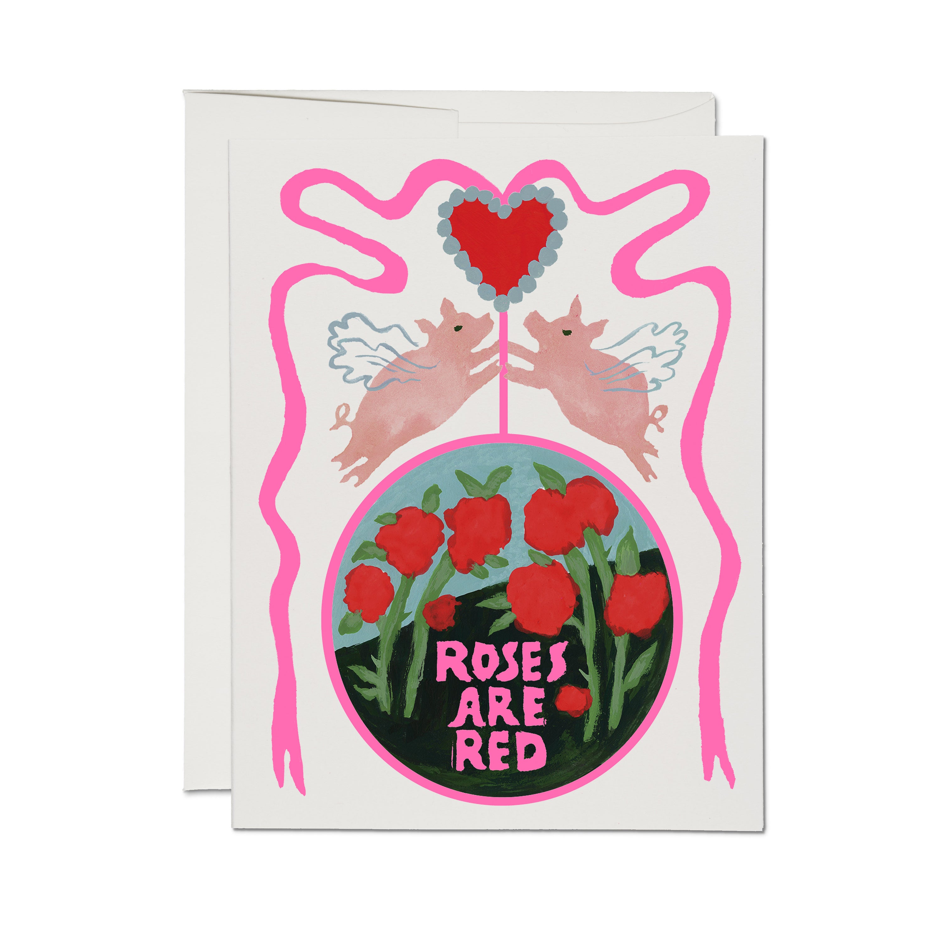 'Roses Are Red' card, two winged pink pigs under a red heart, circle of red roses, pink squiggle border, cream background.