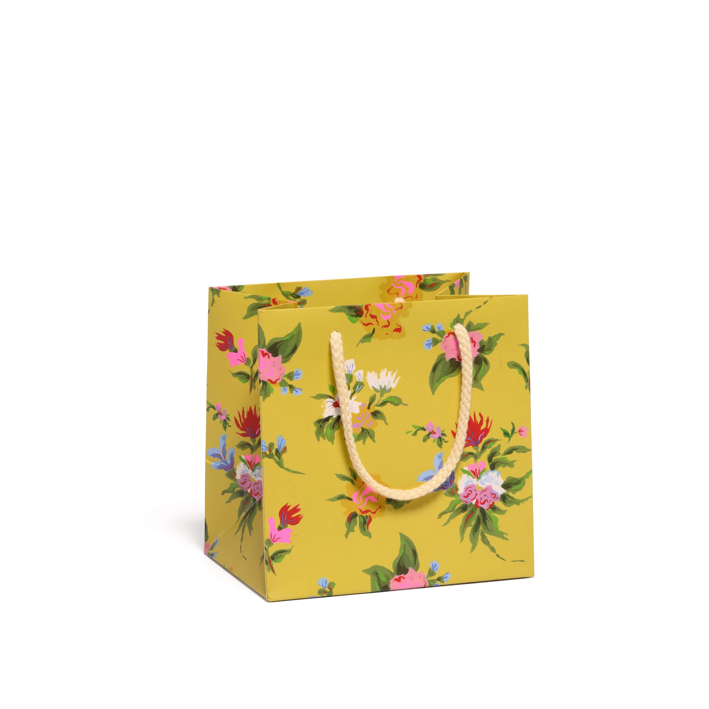 Yellow floral-patterned gift bag with a tan handle on a white background.