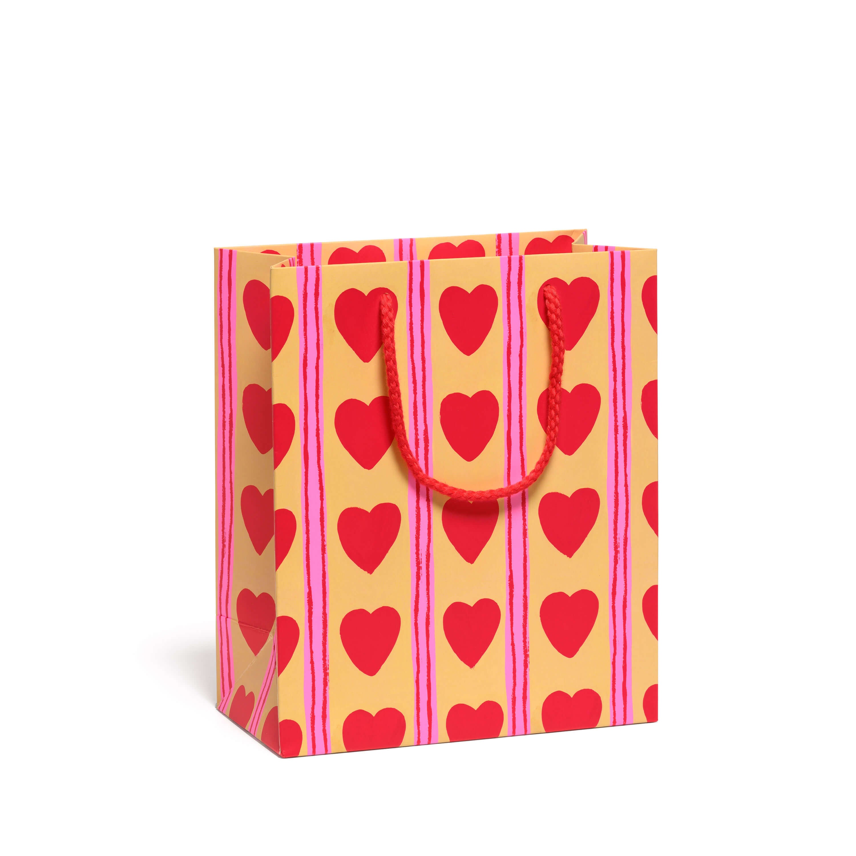 Gift bag with red heart and pink vertical stripe pattern with a red rope handle on a yellow background.