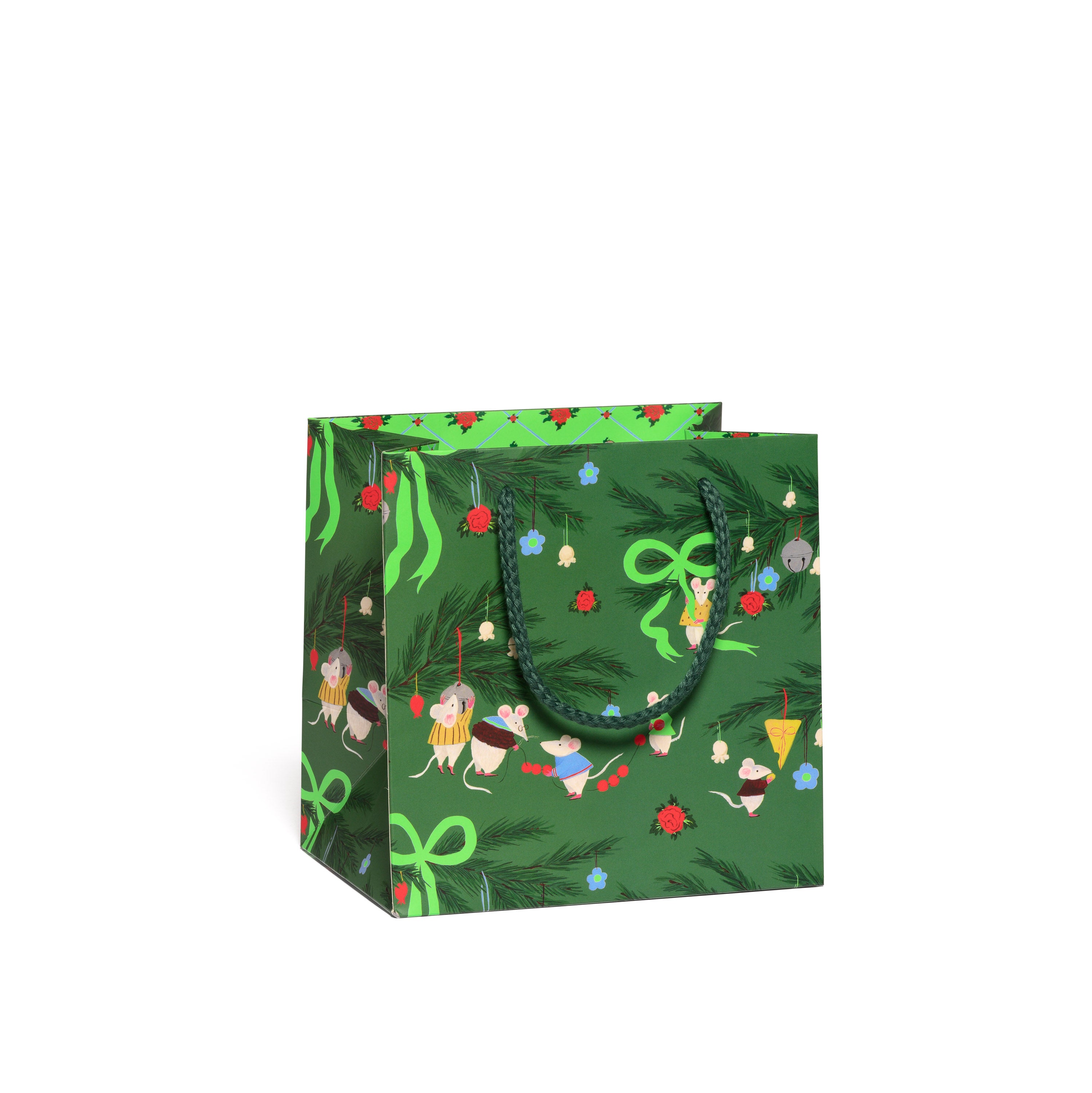 Small green gift bag with festive designs, Christmas decorations and cartoon mice on a green background.