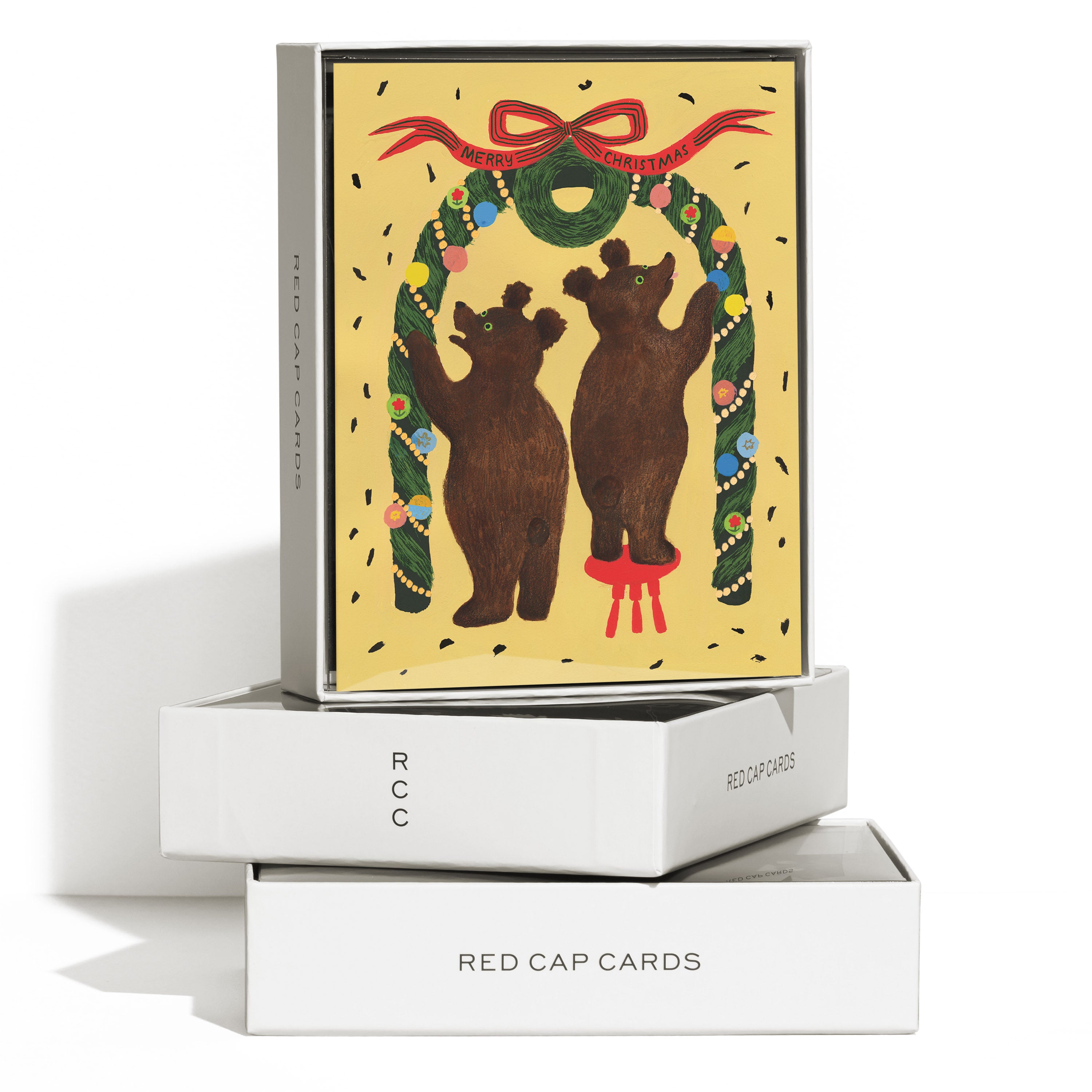 Boxed set of 8 cards with illustrated bears decorating a Christmas arch with "Merry Christmas" text on yellow background.