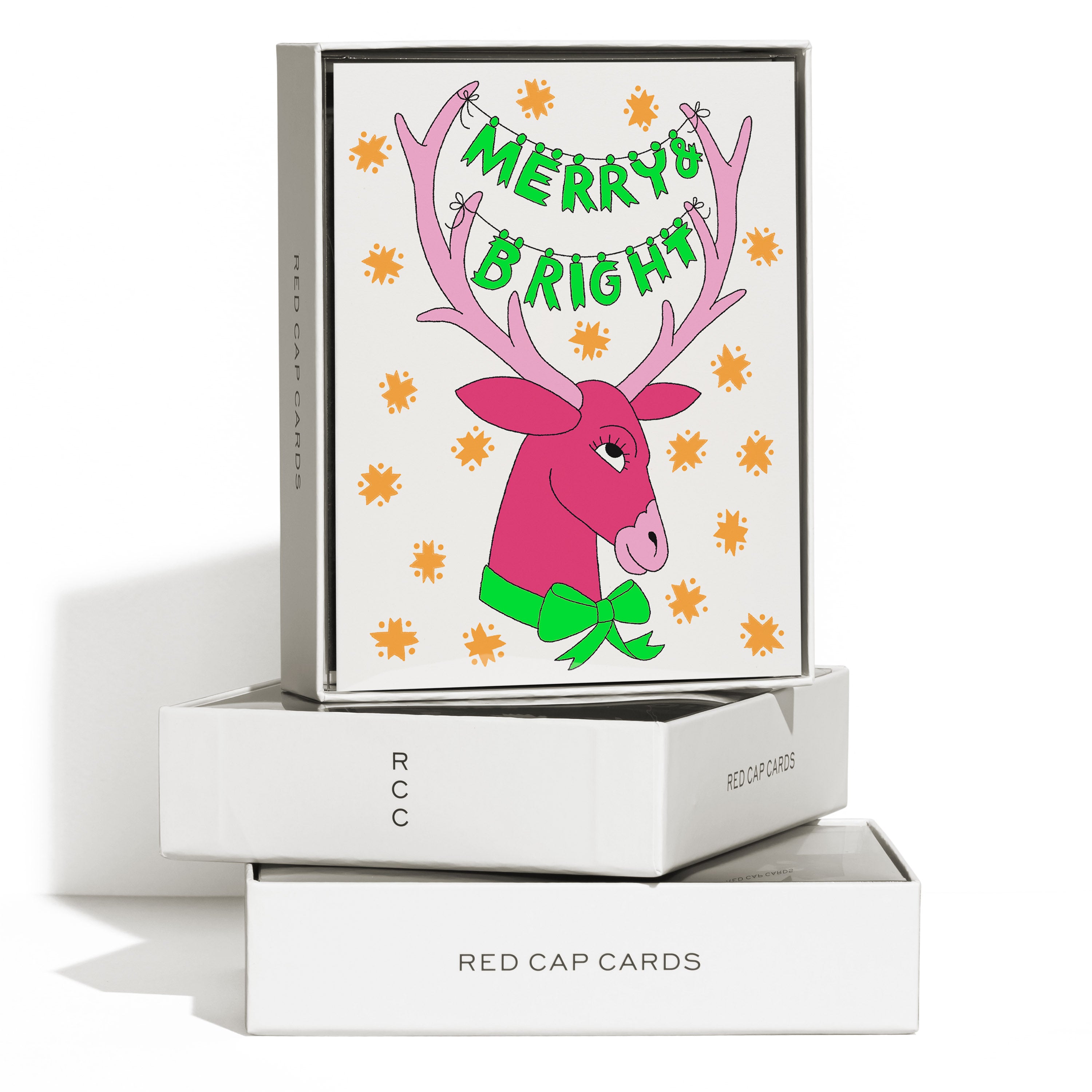 Boxed set of 8 Christmas cards with a pink reindeer with 'Merry + Bright" strung across the antlers.