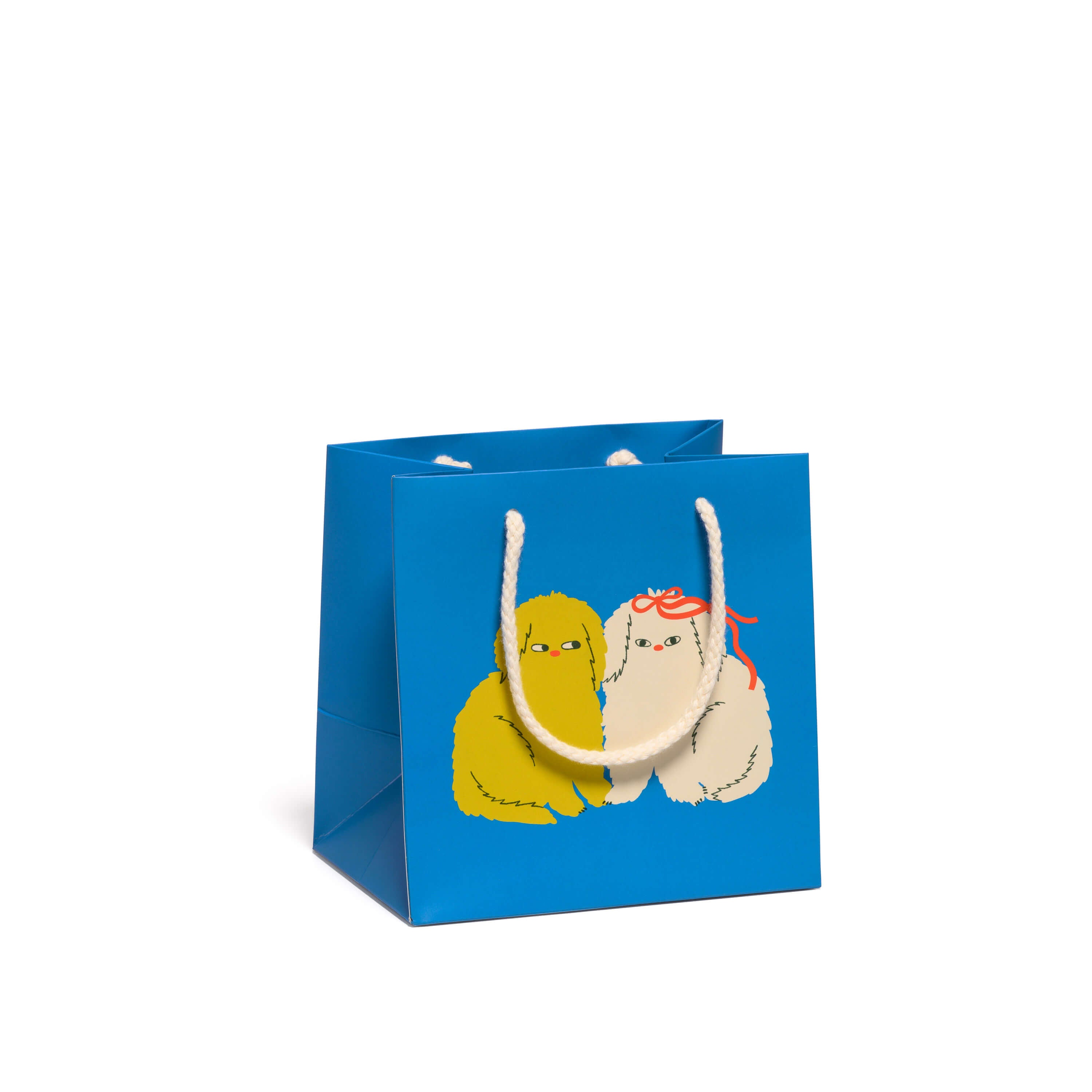 Small Blue gift bag with cartoon dogs on yellow one white with a red bow on a white background.