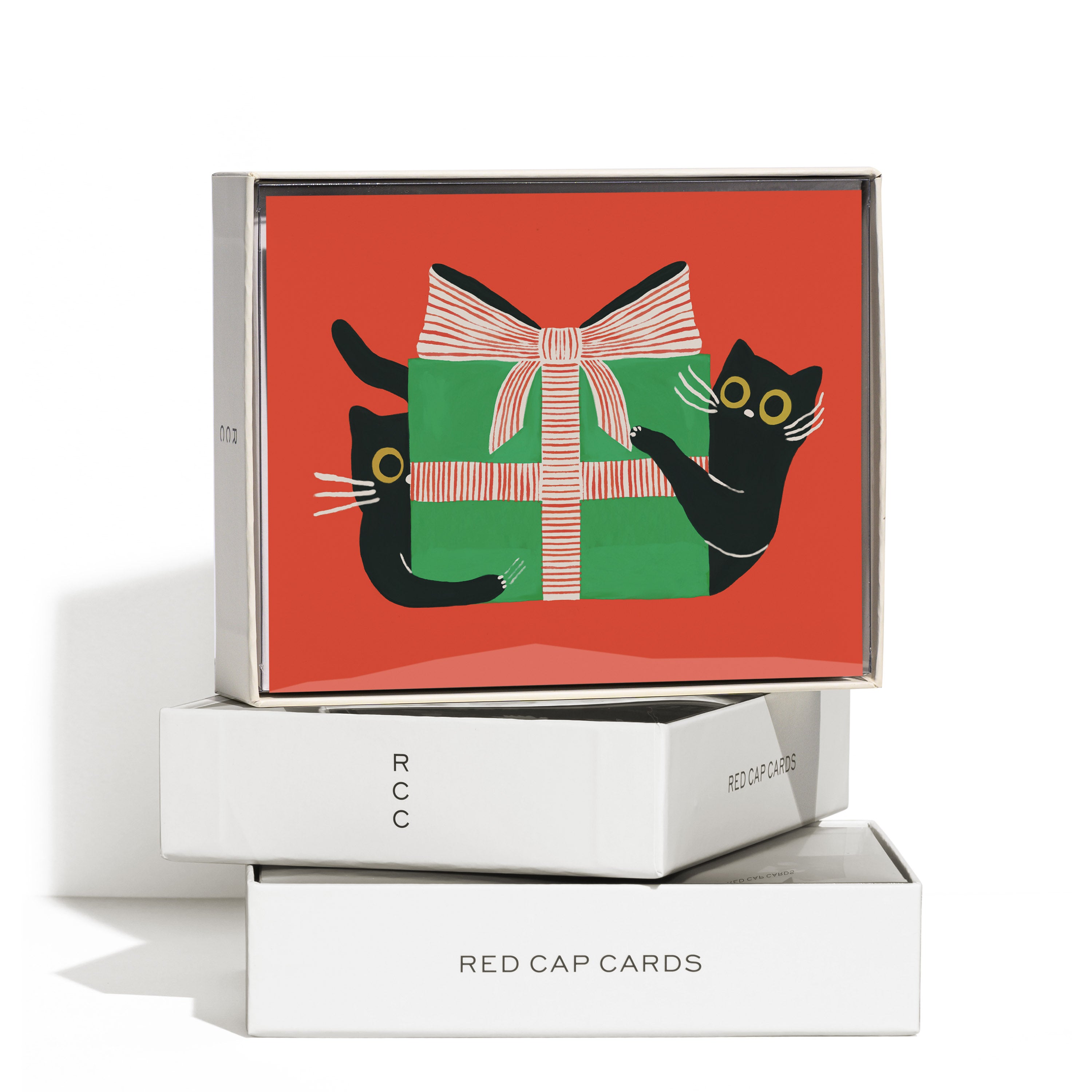Boxed set of 8 Christmas cards with 2 black cats on each side of a green box with red and white striped bow.