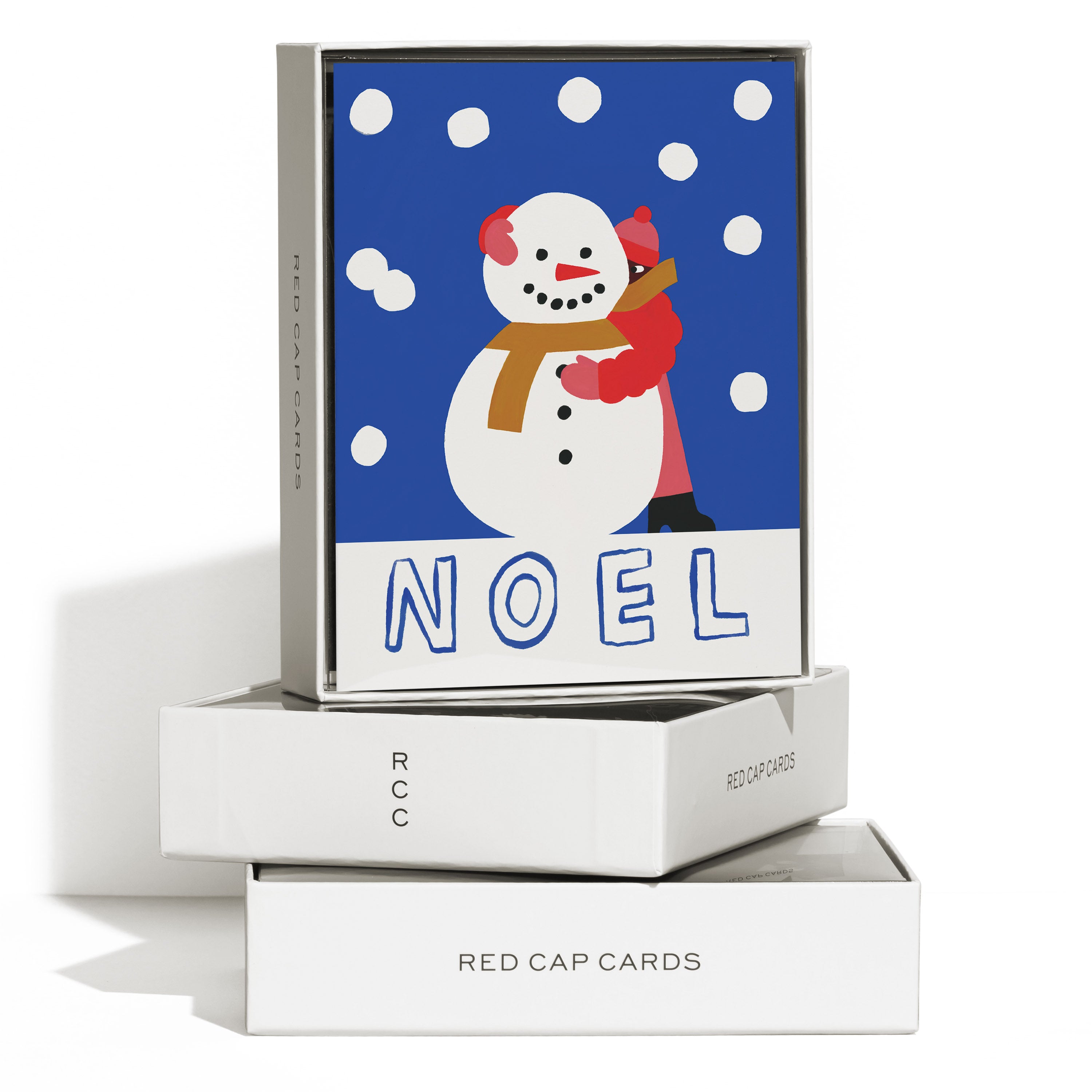 Set of 8 Greeting Cards with person in winter coat hugging a snowman in a snowy field with 'NOEL' text on blue background.