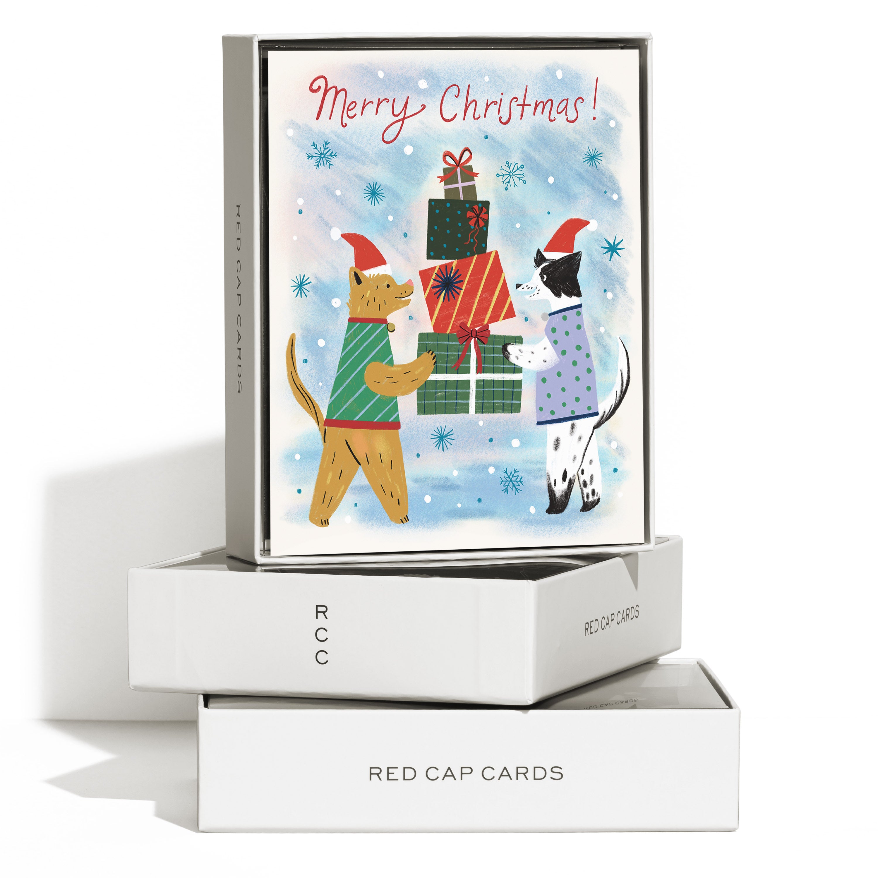 Boxed set of 8 'Merry Christmas!' cards with two cartoon dogs in sweaters holding presents on a snowy winter background.