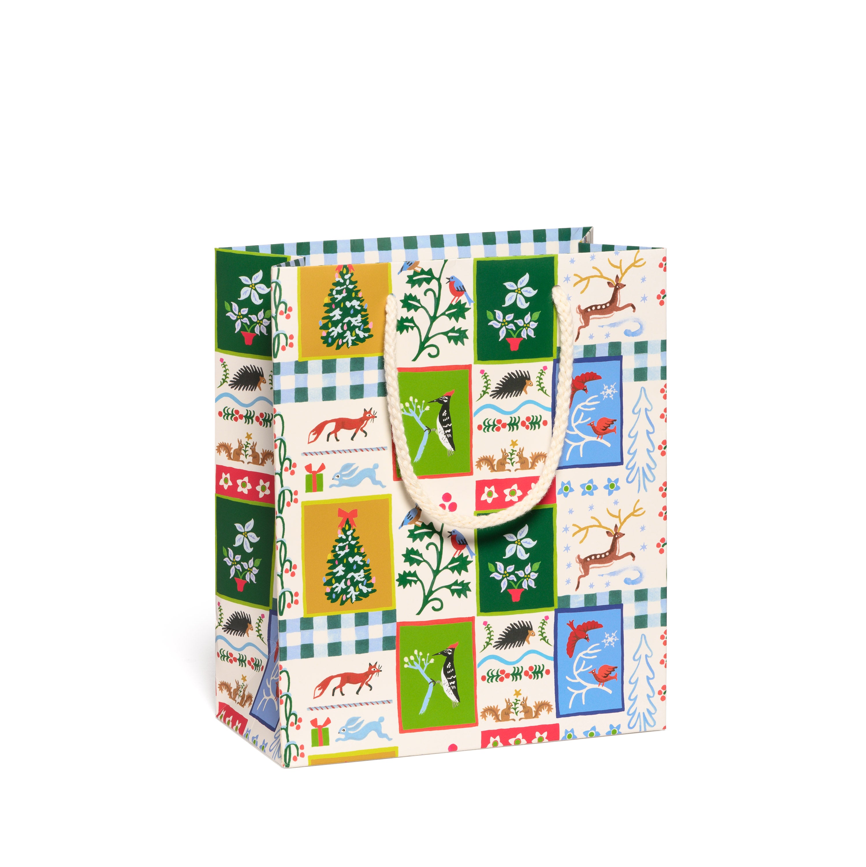 Gift bag with festive pattern featuring trees, animals, and checkered designs on a white background.