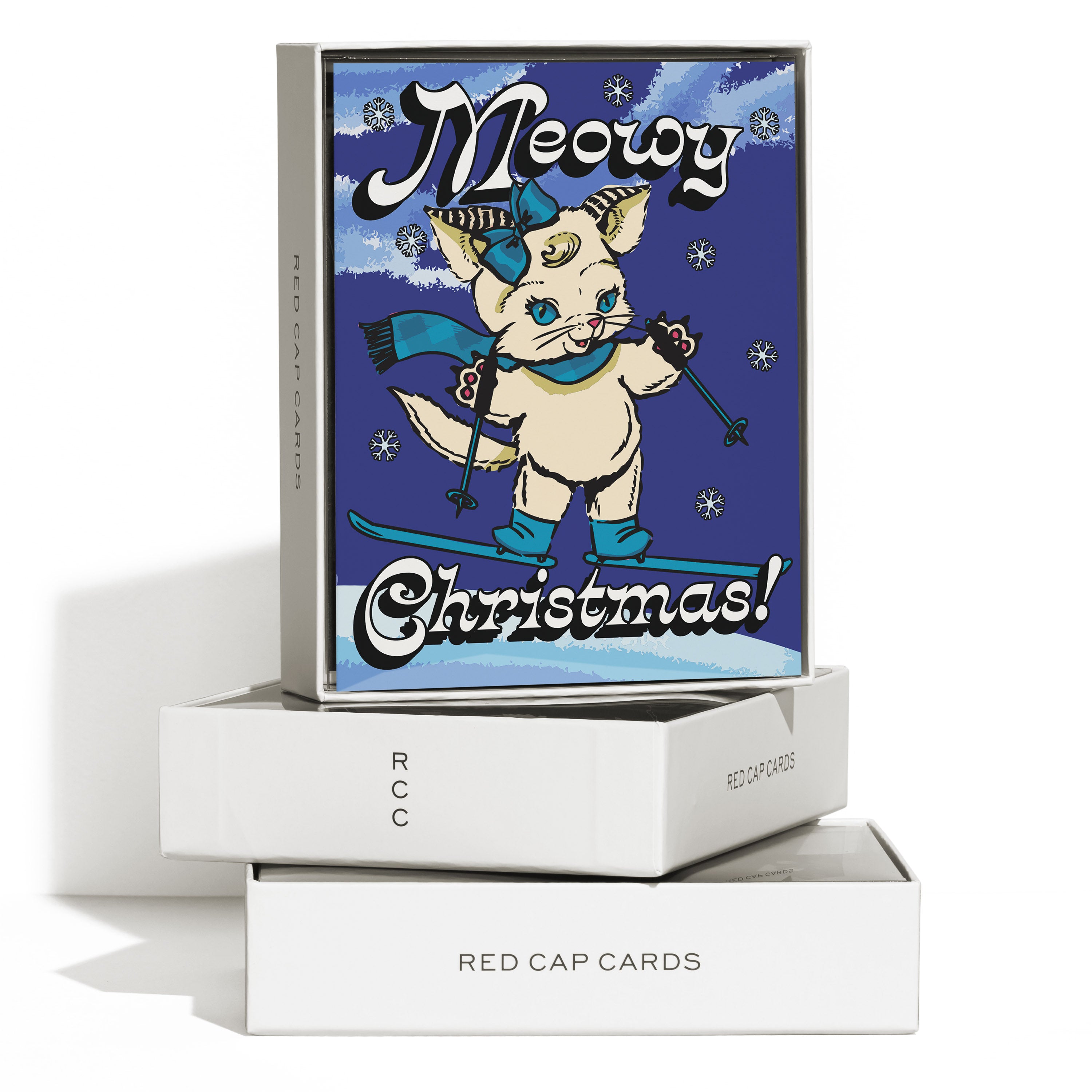 Boxed set of 8 Christmas cards with a cartoon cat wearing a blue bow, scarf, and boots while skiing, 'Meowy Christmas!' text.
