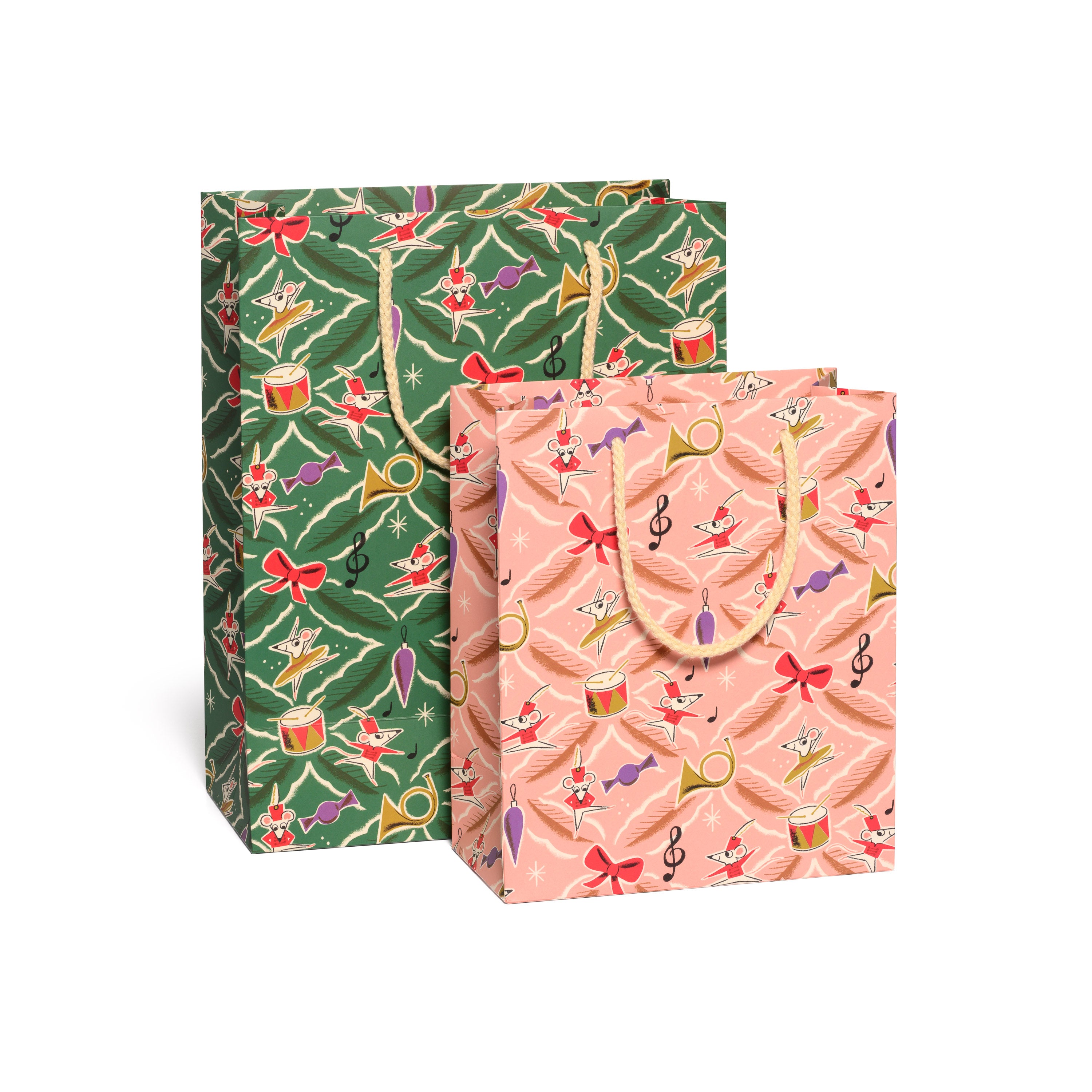 Set of two holiday gift bags one green one pink with assorted festive decorations and a gold rope handle.