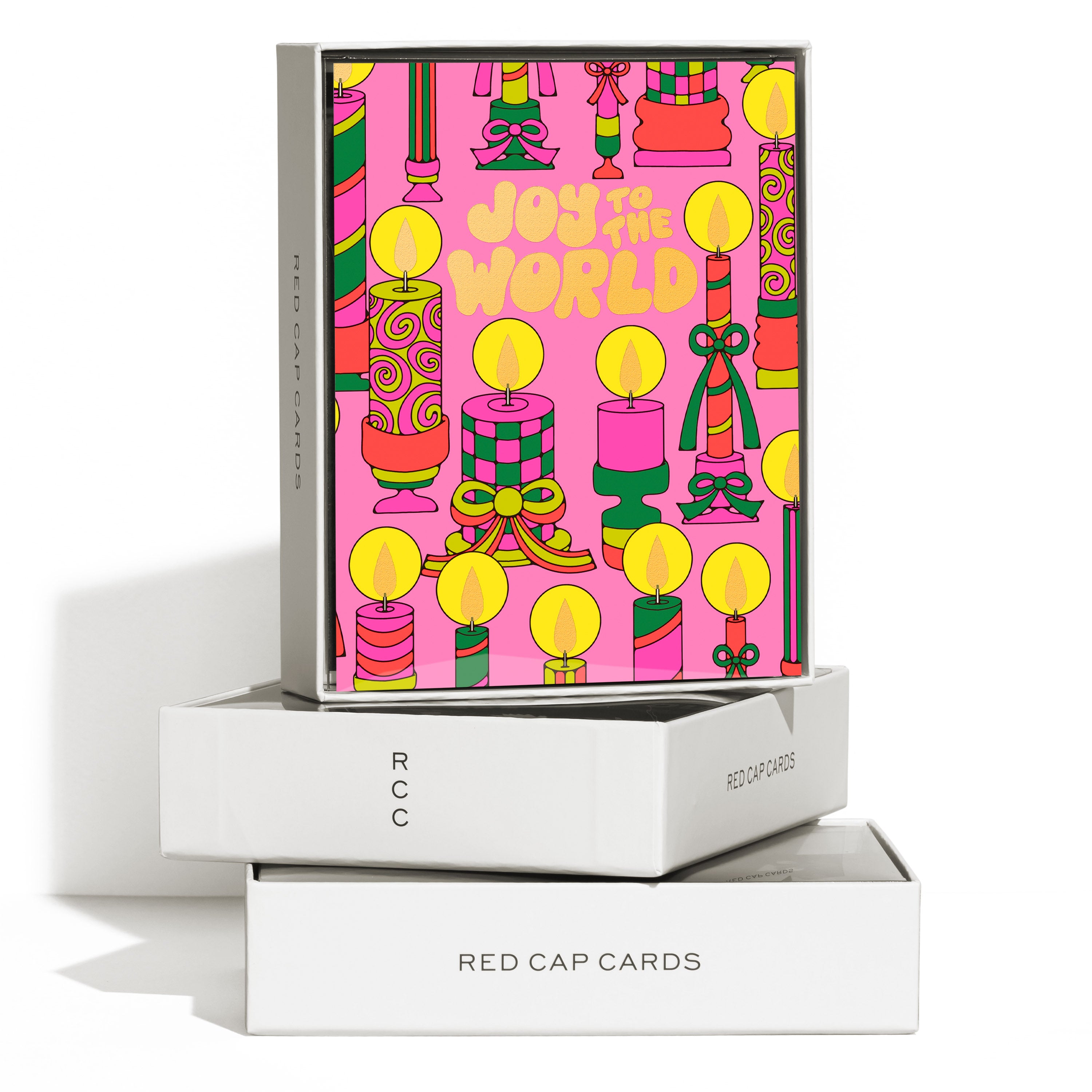 Boxed set of 8 Art deco Christmas cards with different illustrated candles and 'Joy to the World' text on pink background.