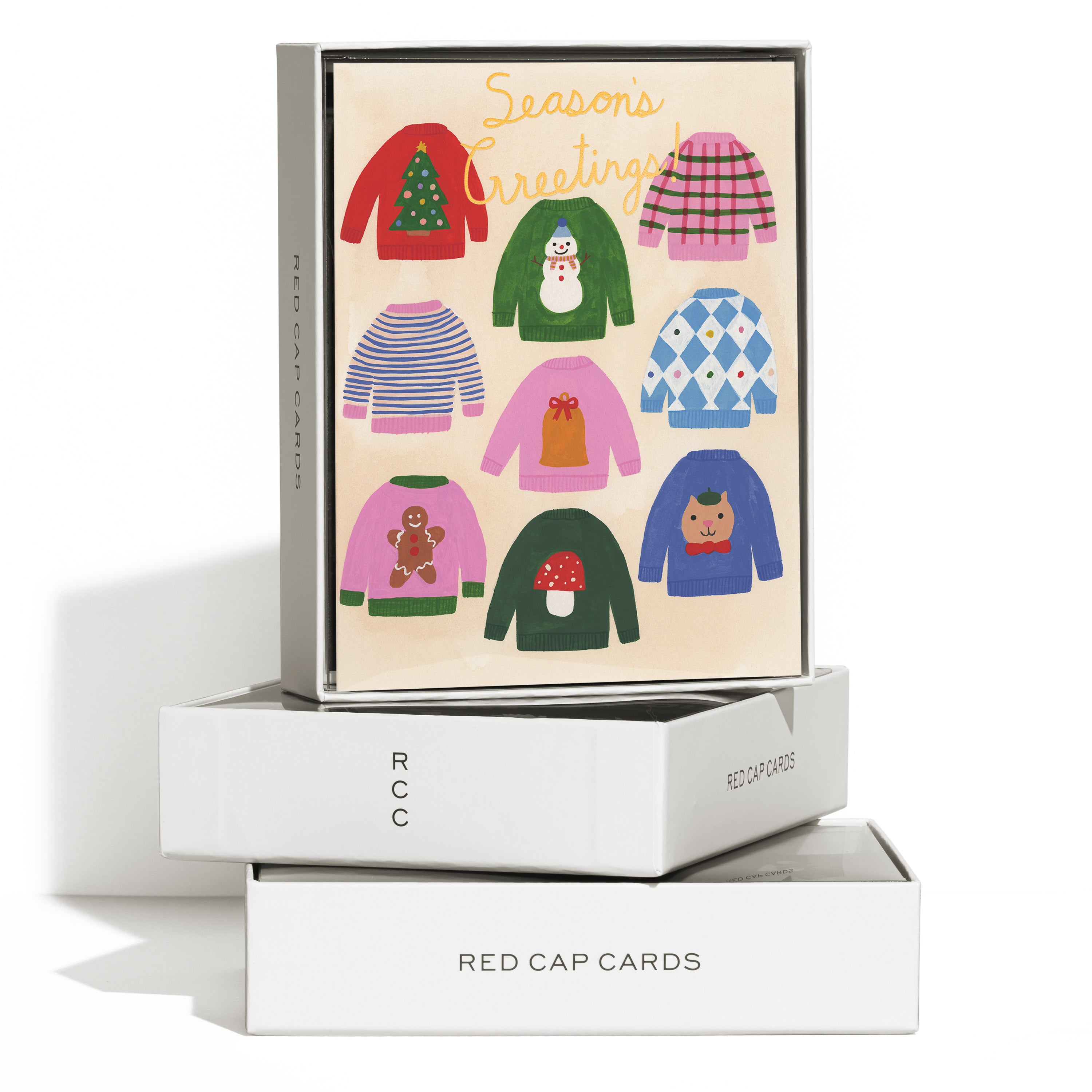 Boxed set of 8 Christmas cards with colorful holiday sweaters and 'Season's Greetings!' gold text on white background.