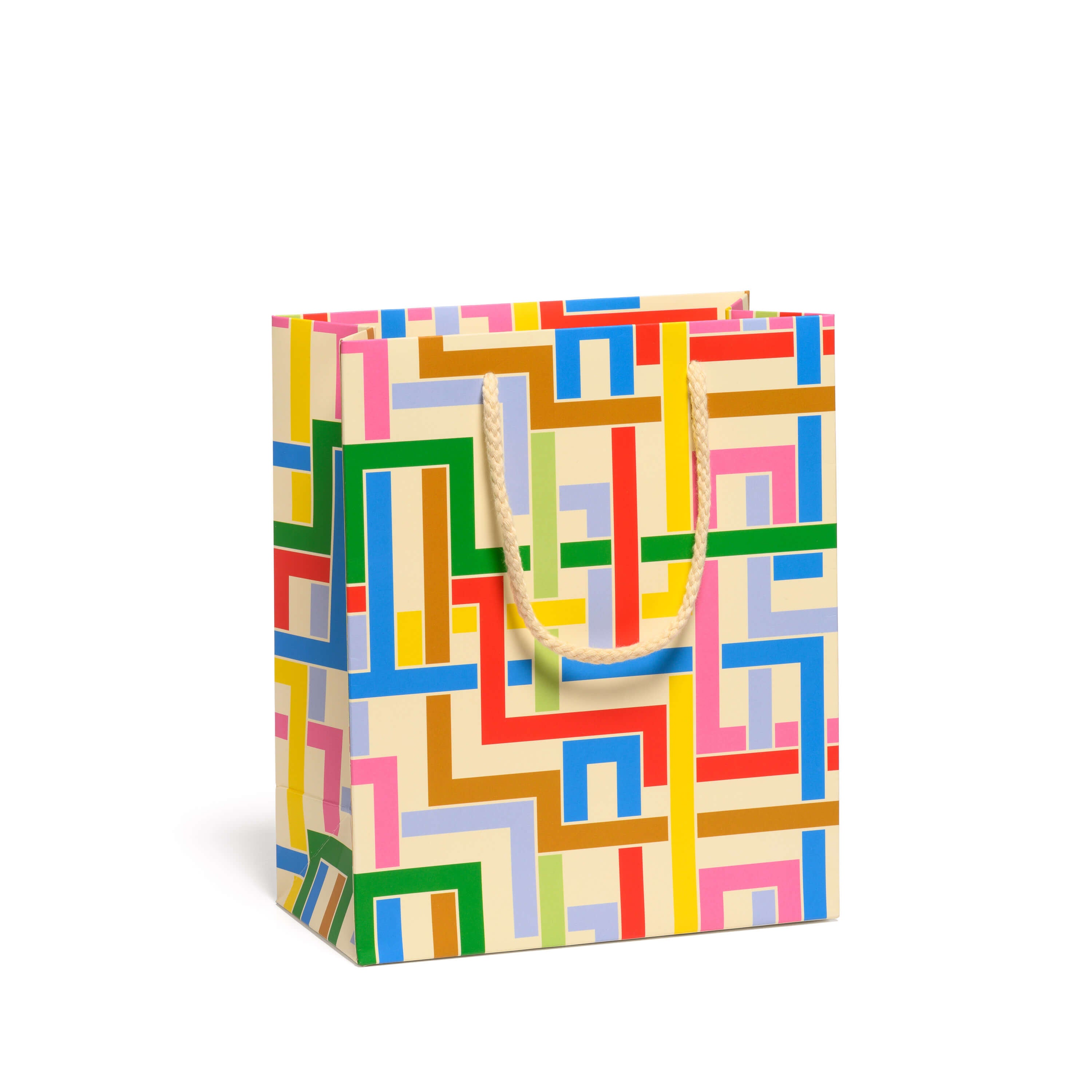 Colorful geometric patterned gift bag with tan rope handle on a white background.