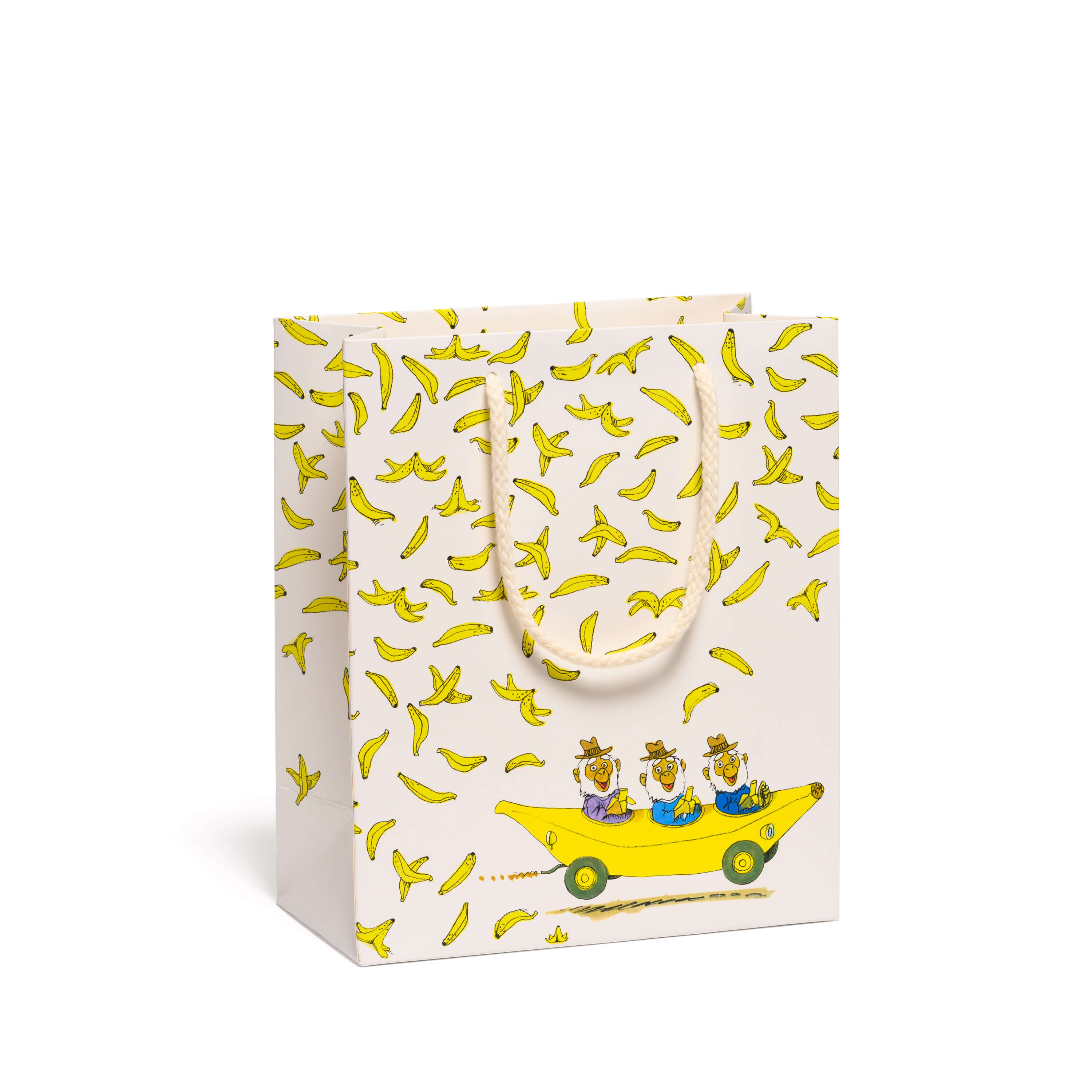 Gift bag with banana pattern and yellow banana vehicle driven by cartoon monkeys design on a white background.