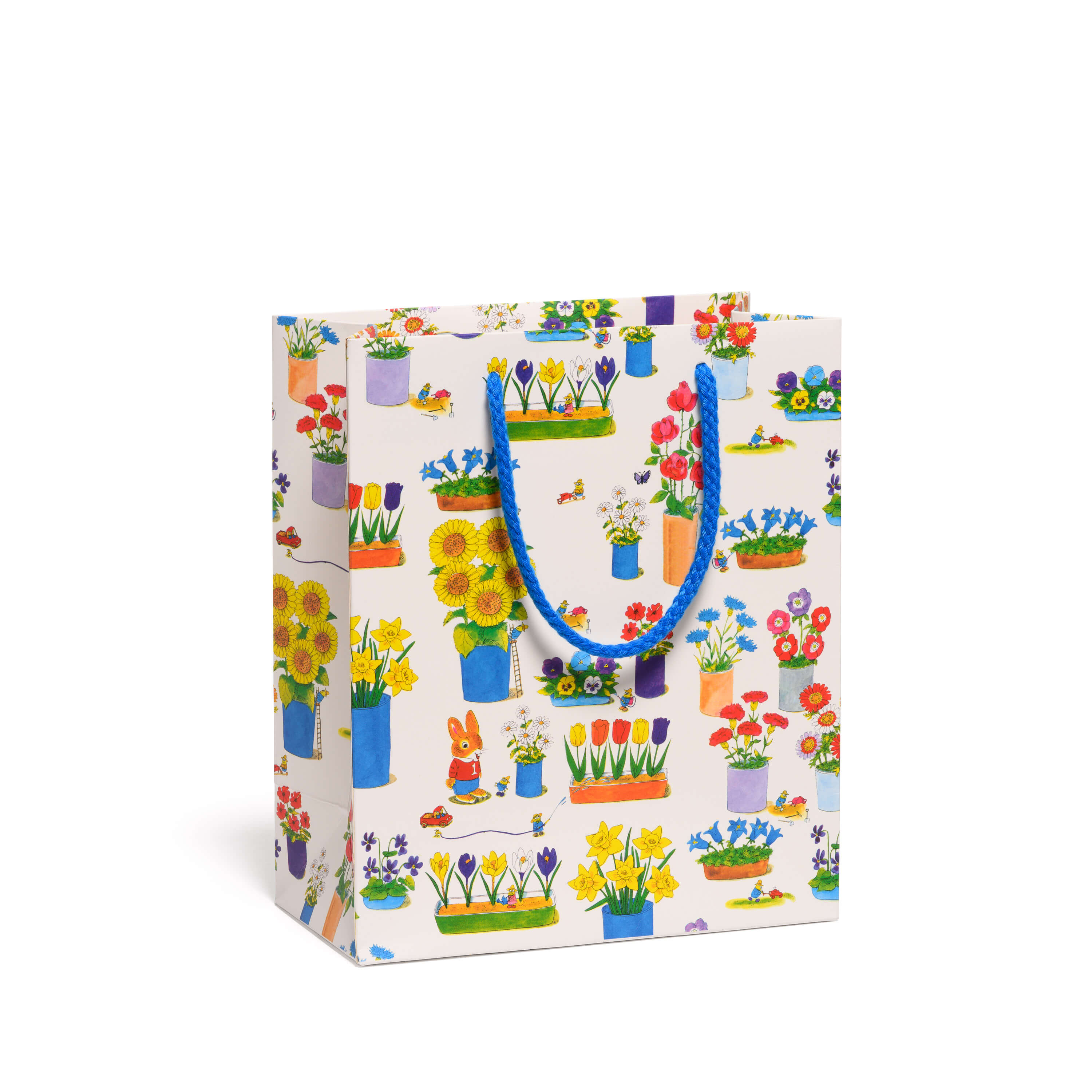 Gift bag with colorful floral and cartoon rabbit design with a blue rope handle on a white background.