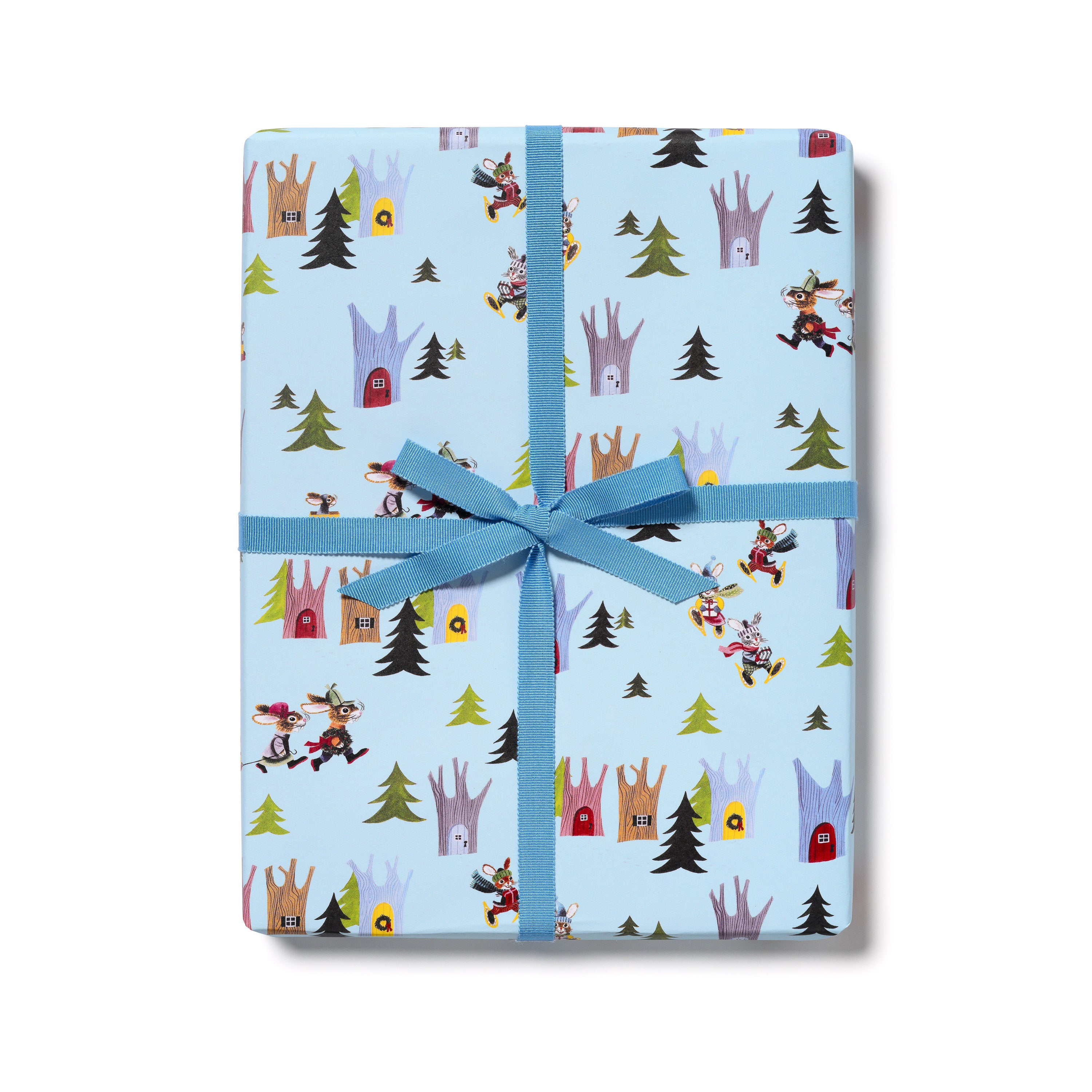 A wrapped gift box with light blue wrapping paper featuring a pattern of tree houses and rabbits, tied with a blue ribbon.