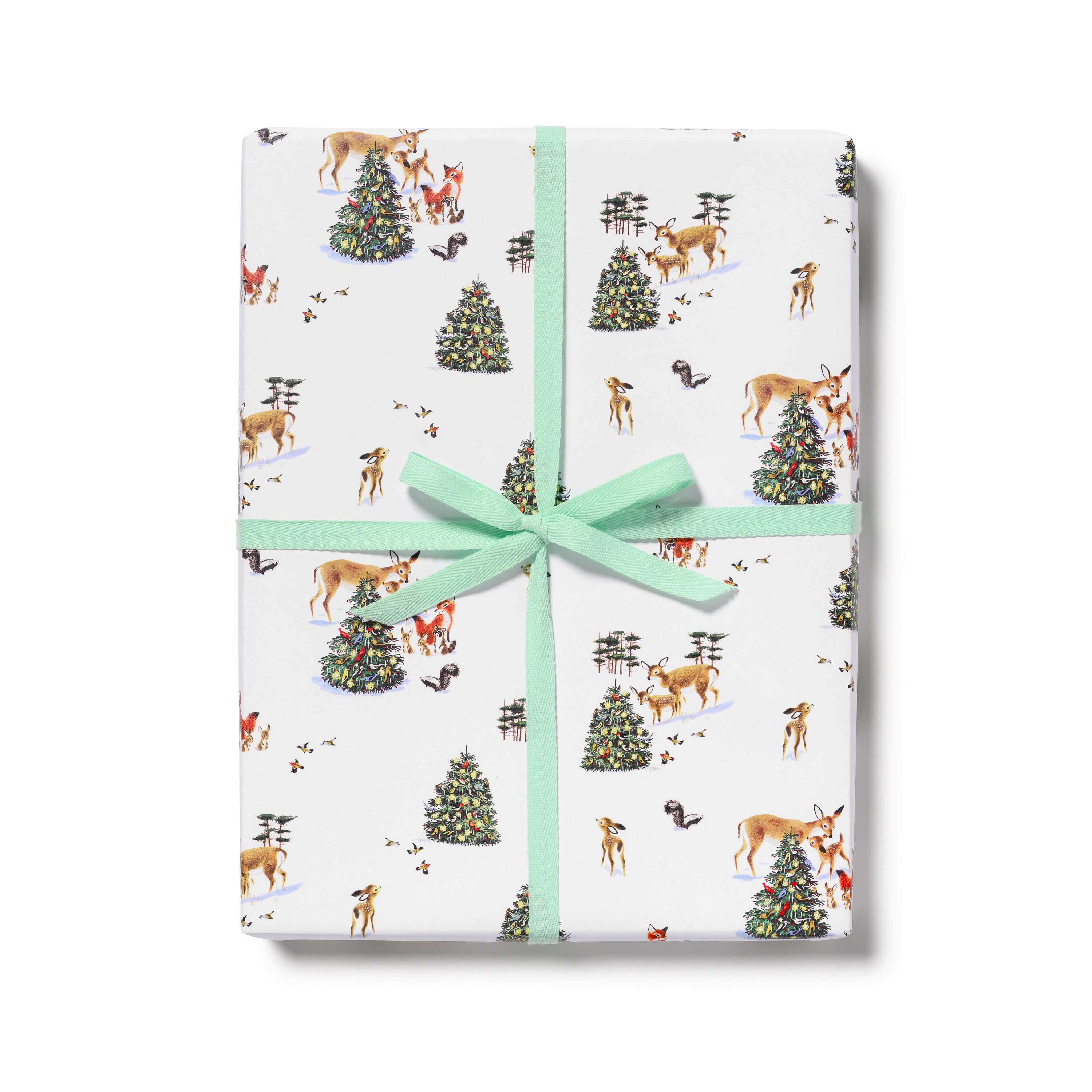 Wrapping paper with illustrated woodland snowy scene with Christmas tree and deer, foxes and skunk with teal ribbon.