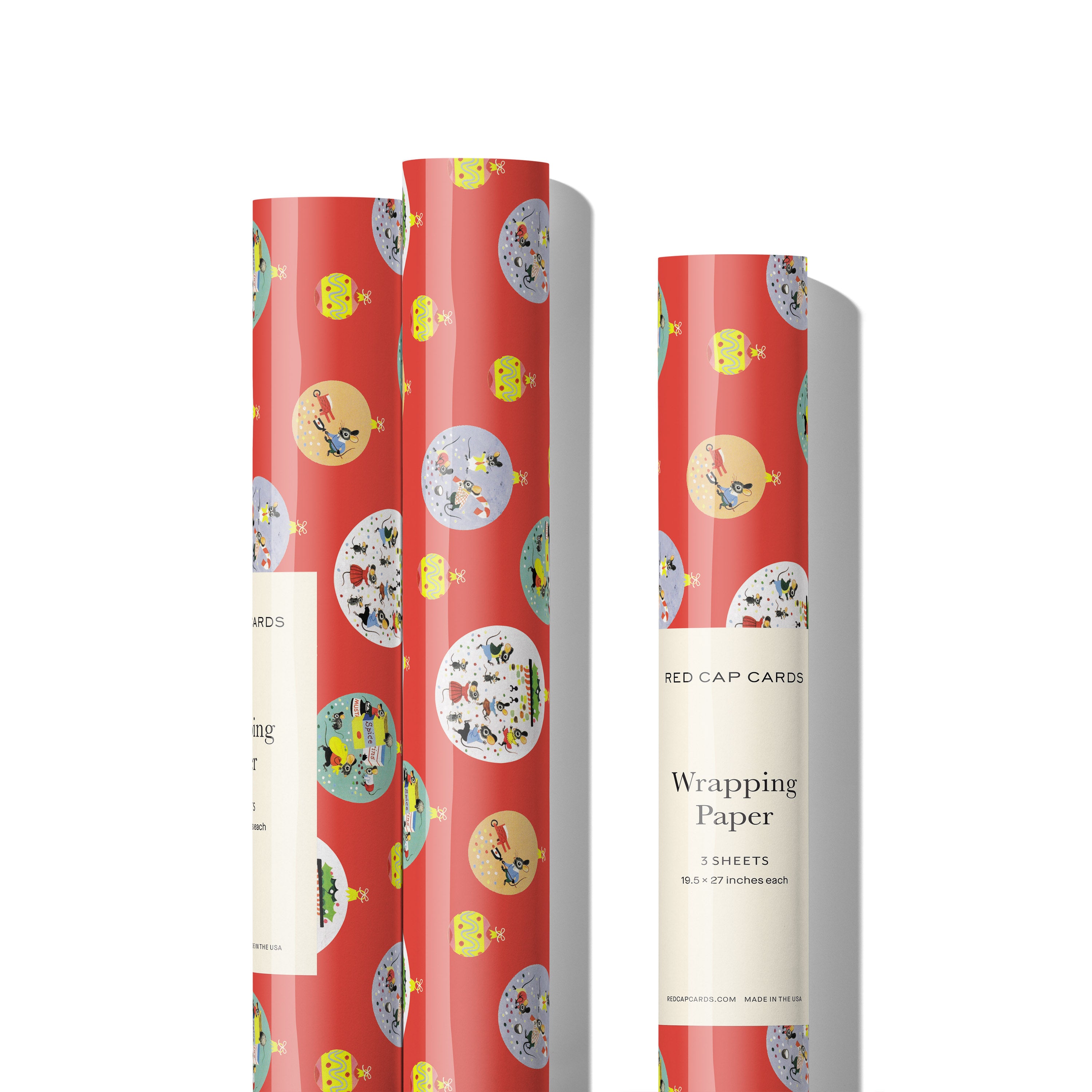 Three rolls of Bright red wrapping paper with colorful cartoon Christmas scenes depicted with animals in different ornament baubles.