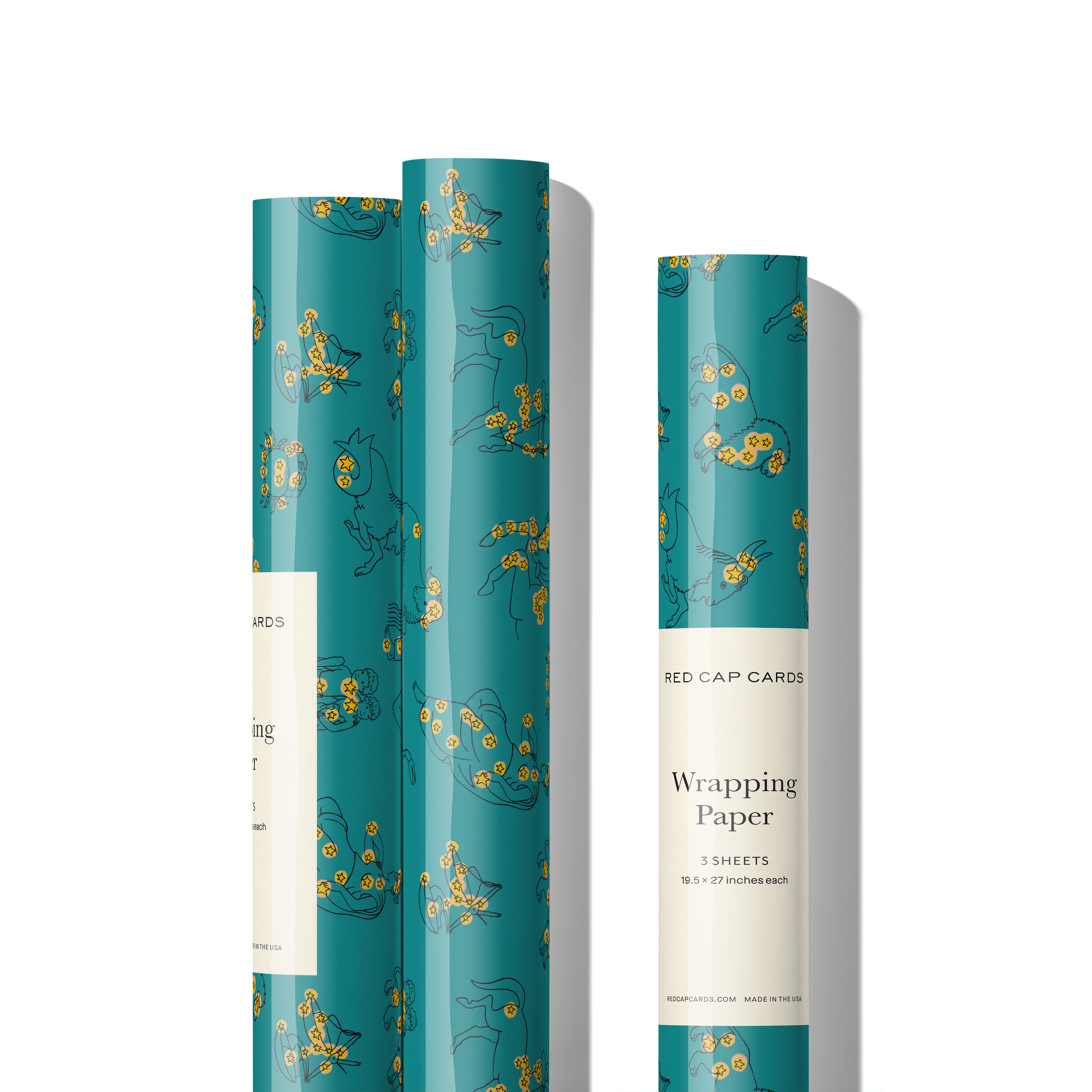 Three rolls of gift wrap with Zodiac patterns and yellow stars on a teal background.