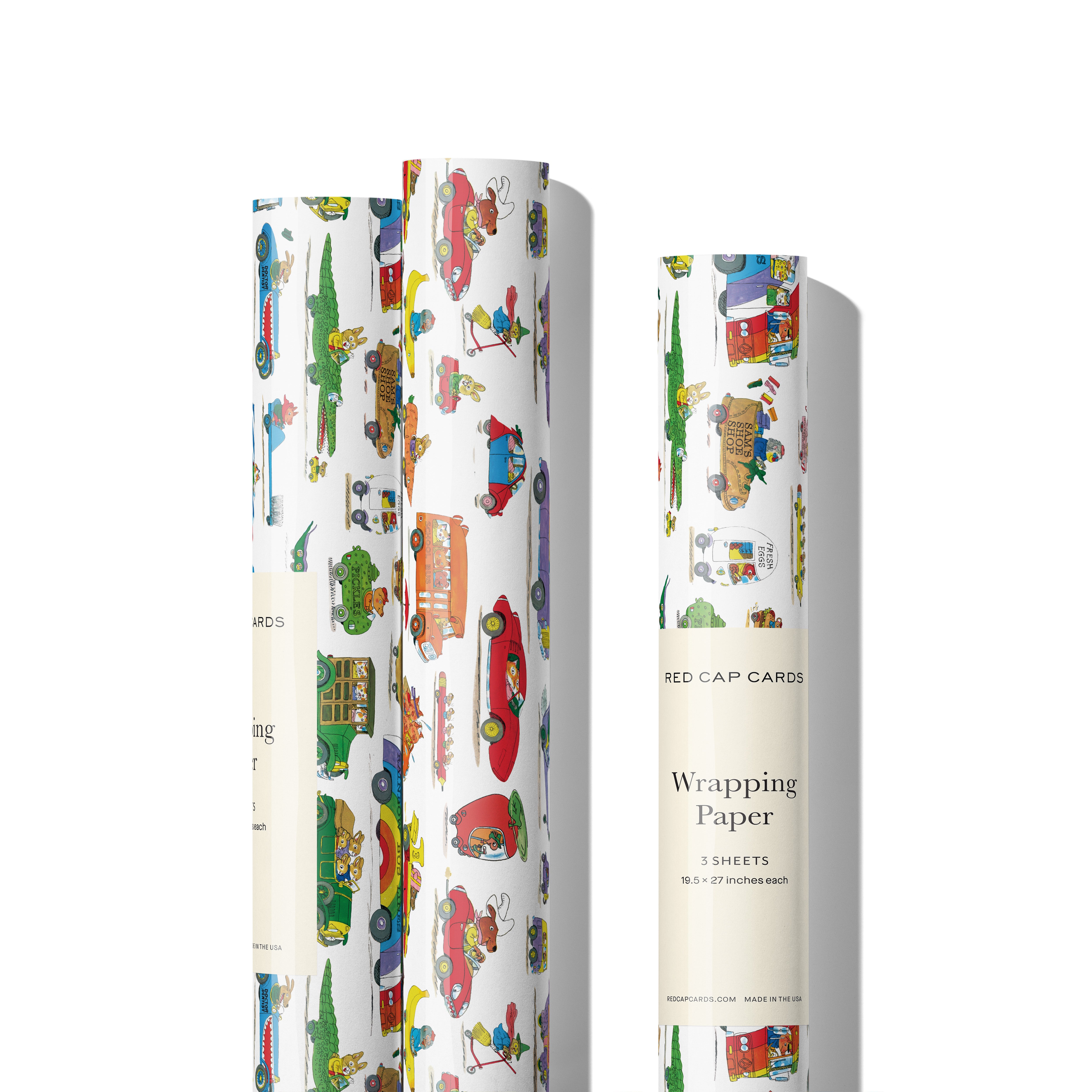 Three rolls of Busytown themed vehicles gift wrap on white background.