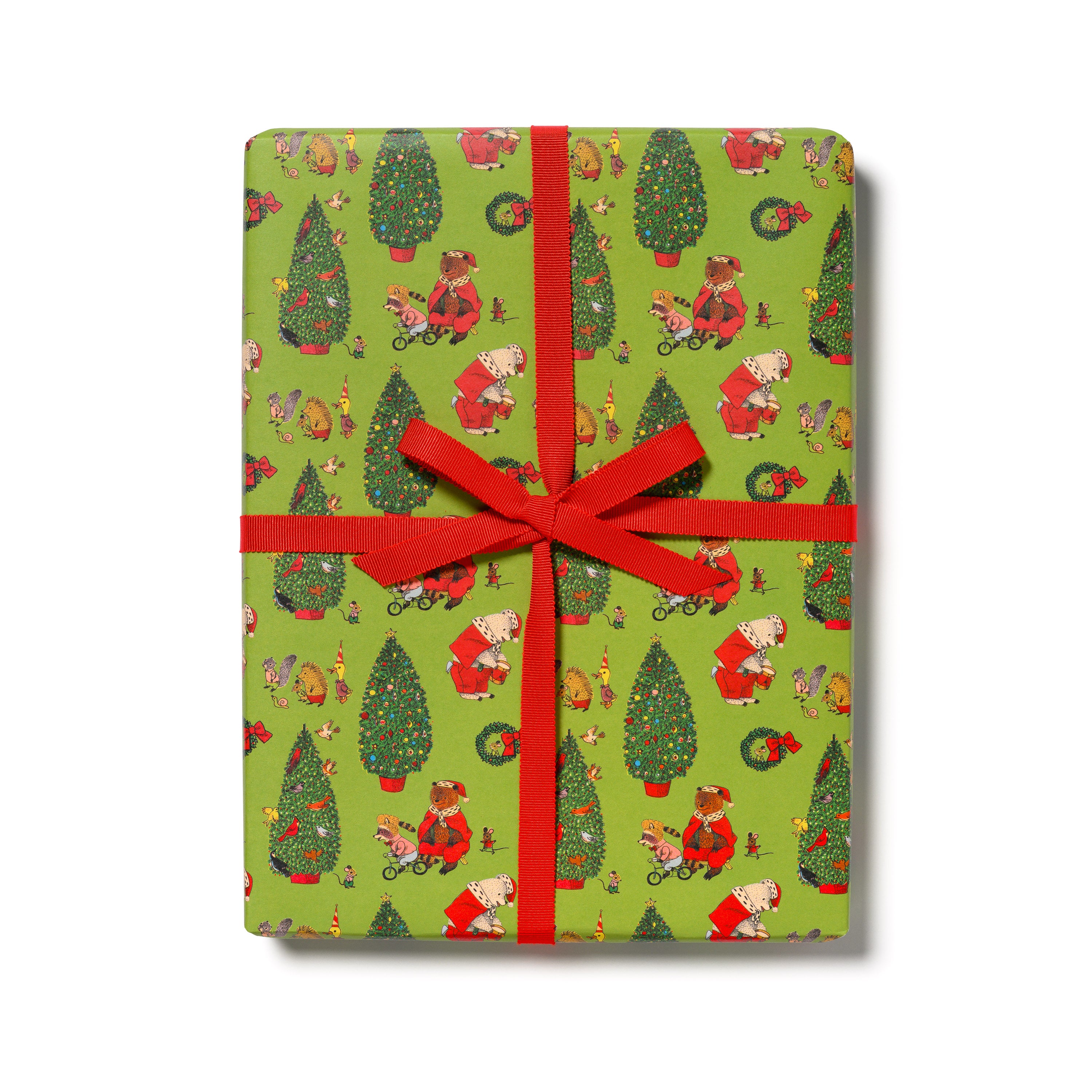 Gift wrap with Christmas tree, woodland creatures and cartoon bears dressed as Santa Claus with a red ribbon. 