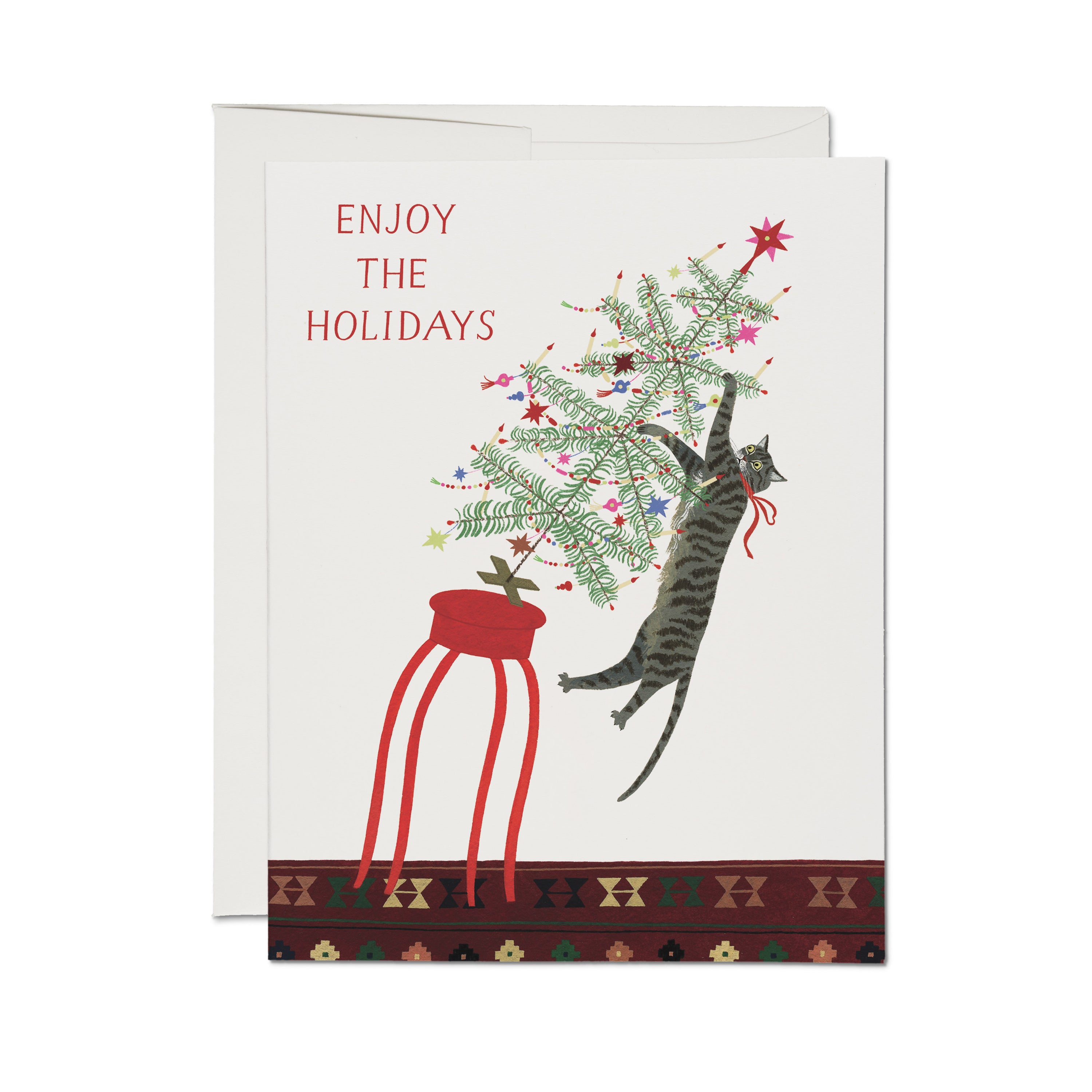 Christmas card with illustrated cat toppling over a Christmas Tree with red 'Enjoy the Holidays' text on white background.