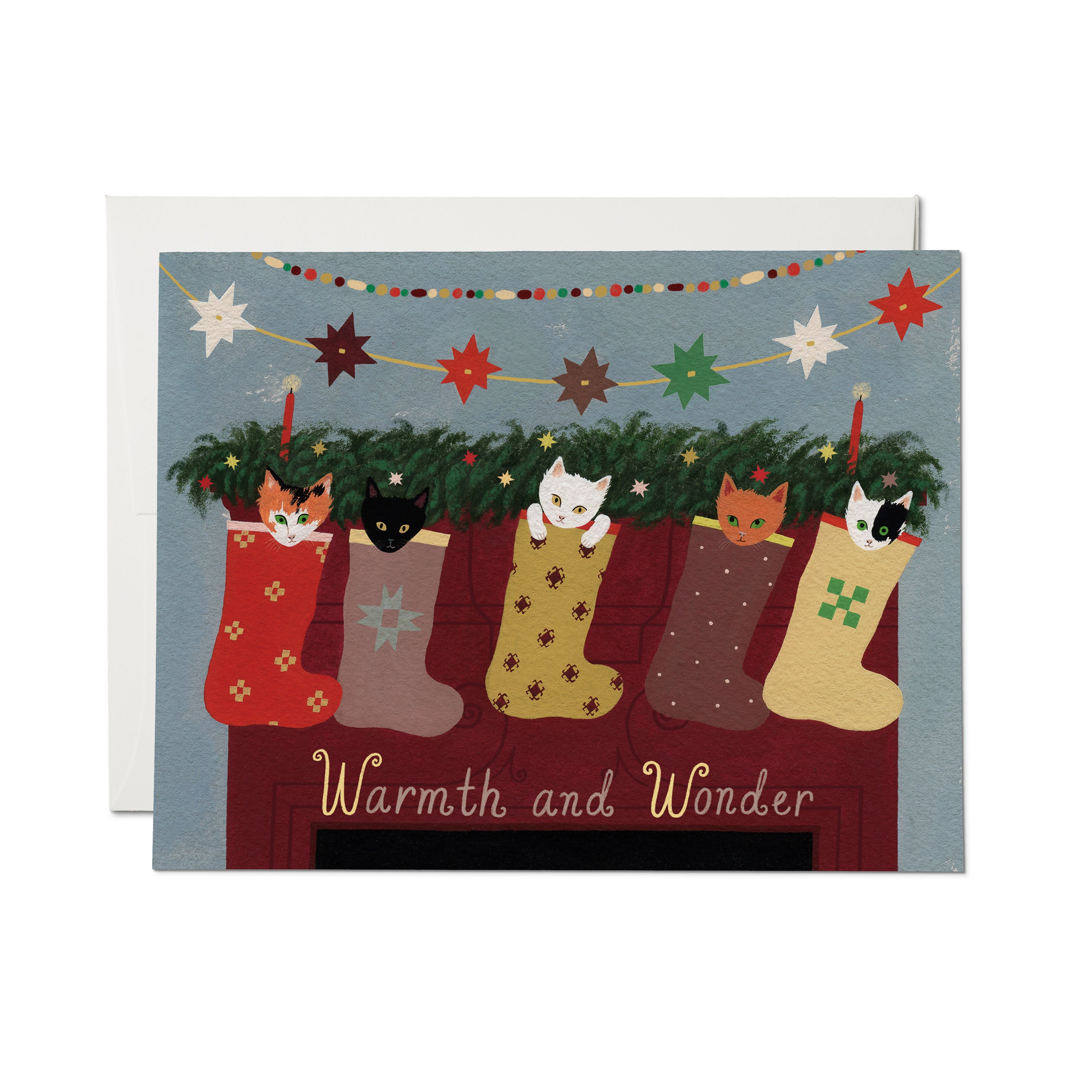 Christmas card with illustrated stockings filled with kittens on fireplace mantle and 'Warmth and Wonder' text.