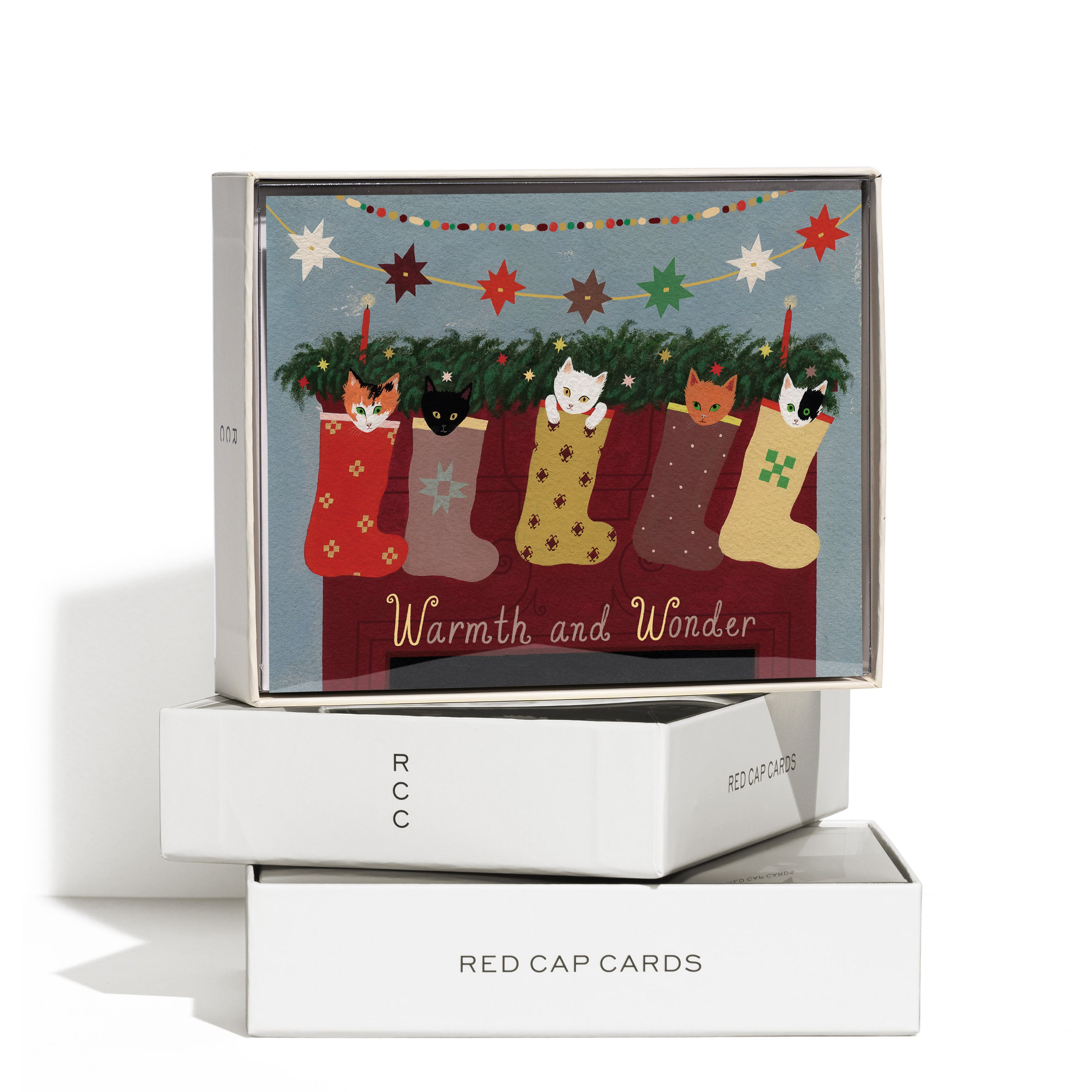 Boxed set of 8 Christmas cards with illustrated stockings filled with kittens on fireplace mantle and 'Warmth and Wonder' text.