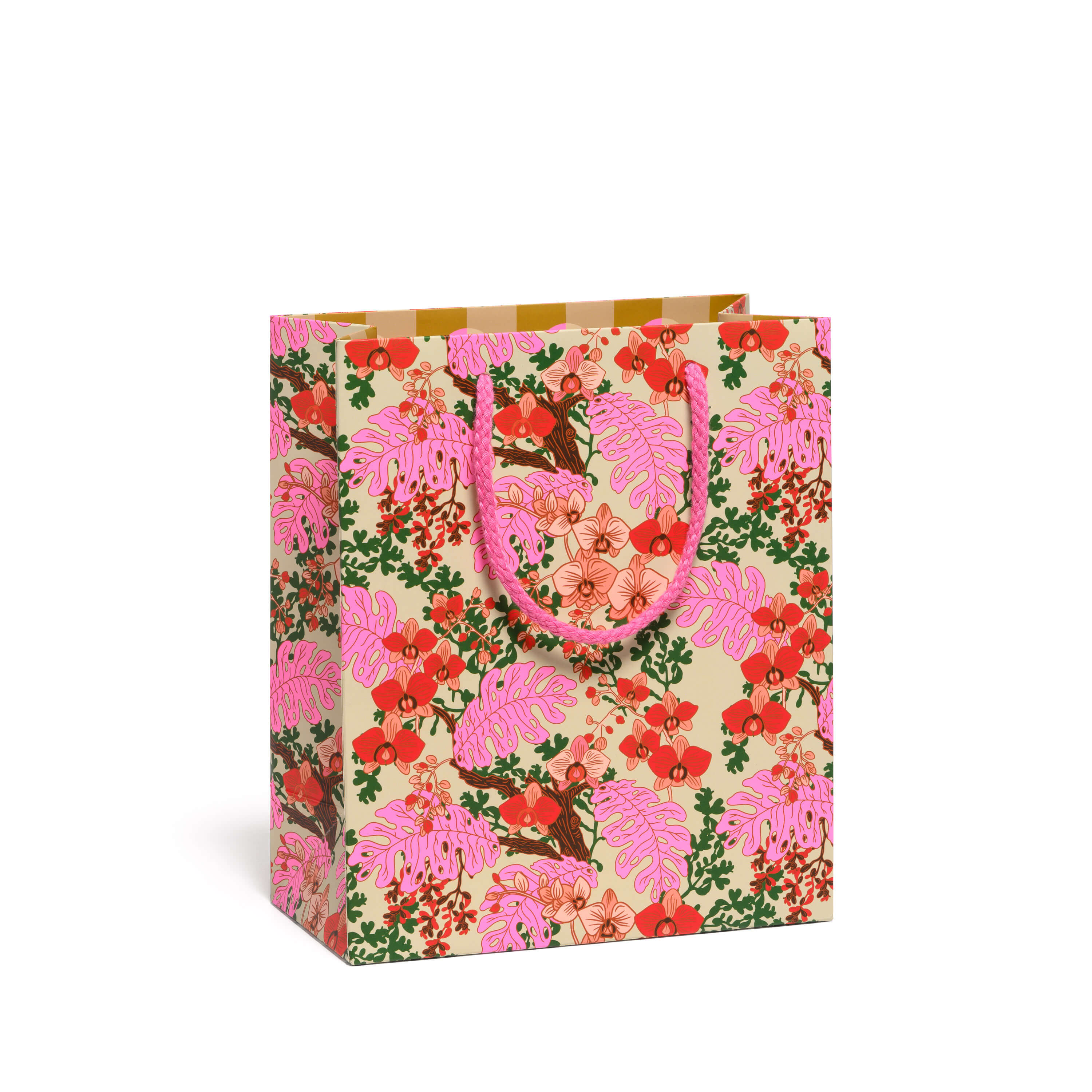 Floral patterned gift bag with pink handles on a white background.