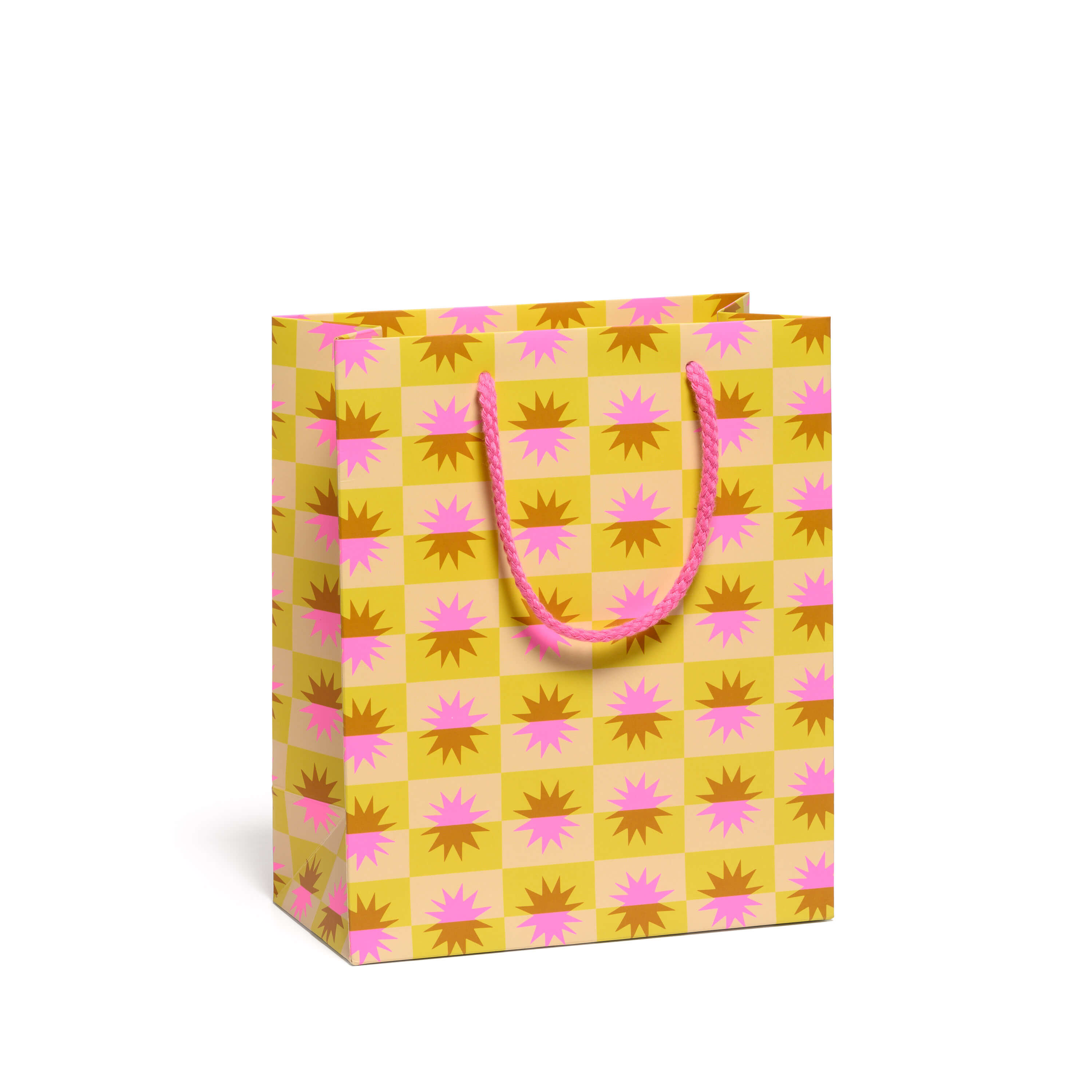 Yellow, brown  and pink checkered gift bag with starburst design and a pink handle on a white background.
