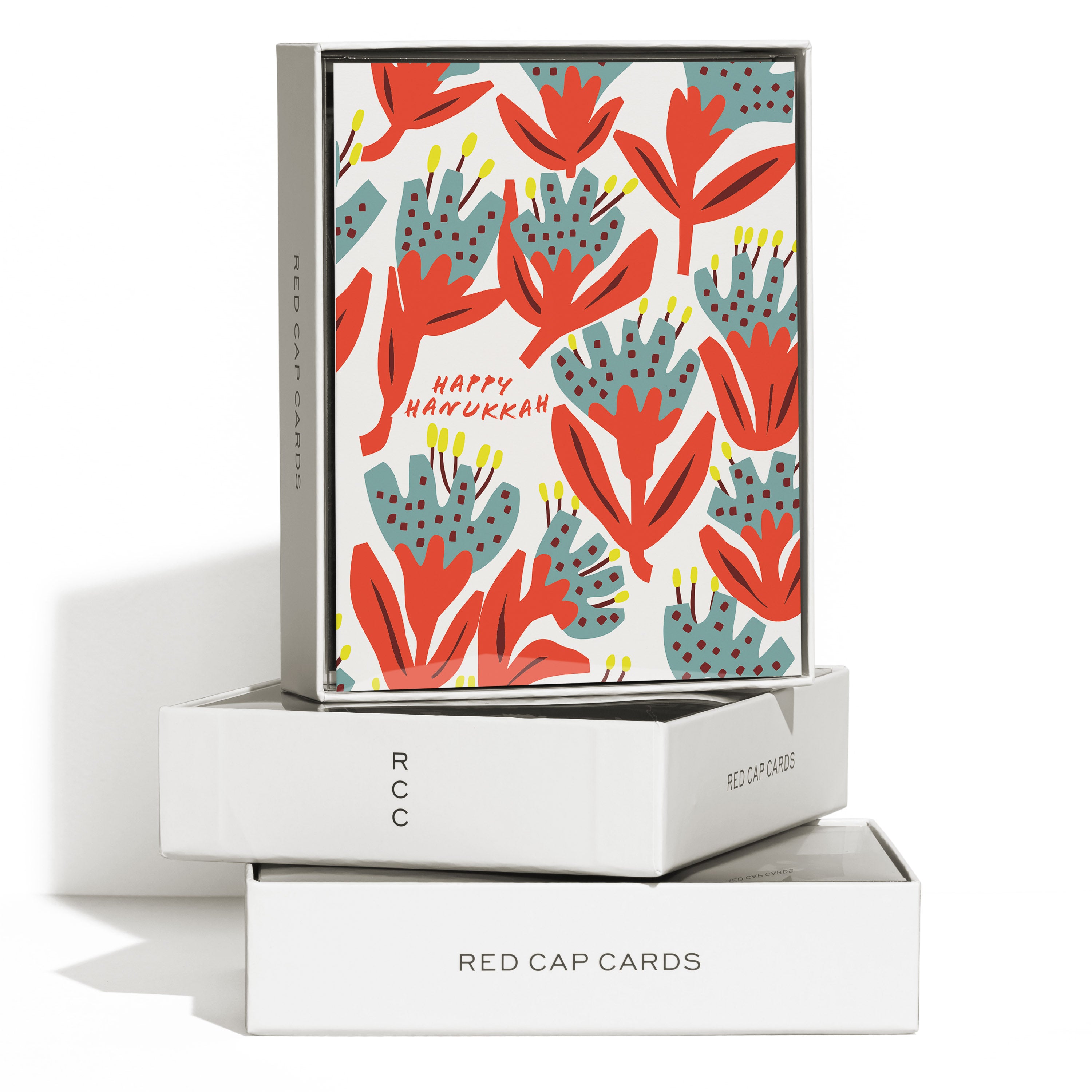 Boxed set of 8 Greeting Cards with colorful illustrated floral design and red 'Happy Hanukkah' text on white background.