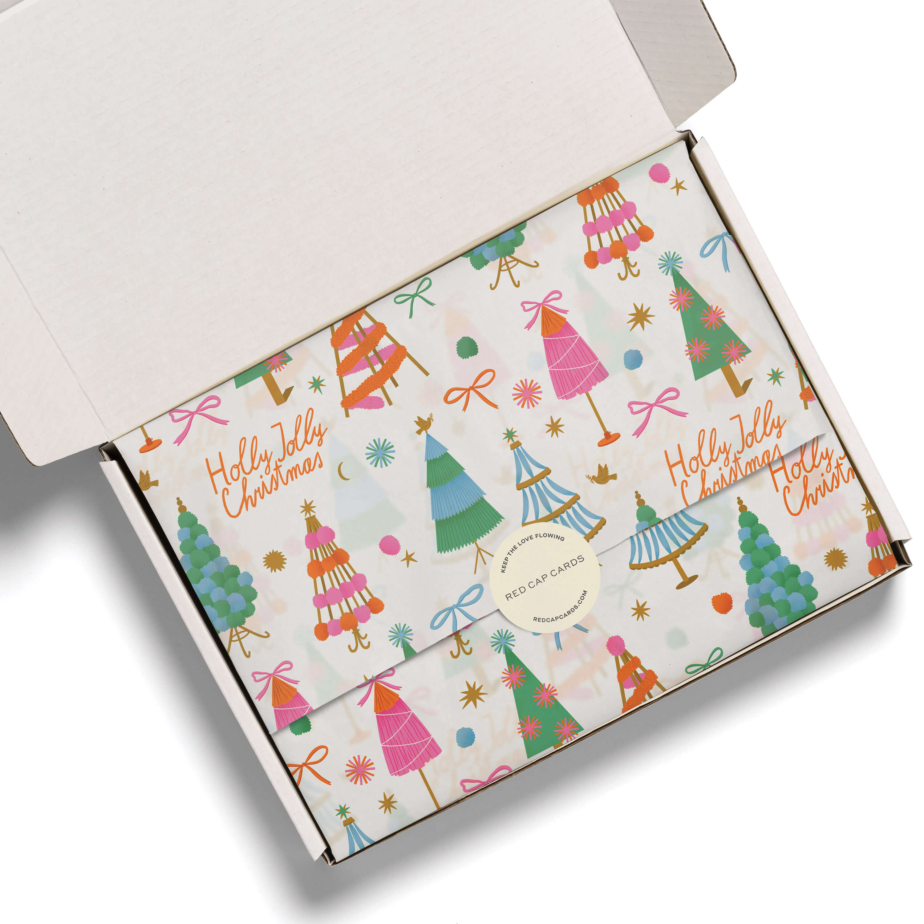Tissue paper with mid century modern illustrated Christmas tree design with "Holly Jolly Christmas" text in a white box.